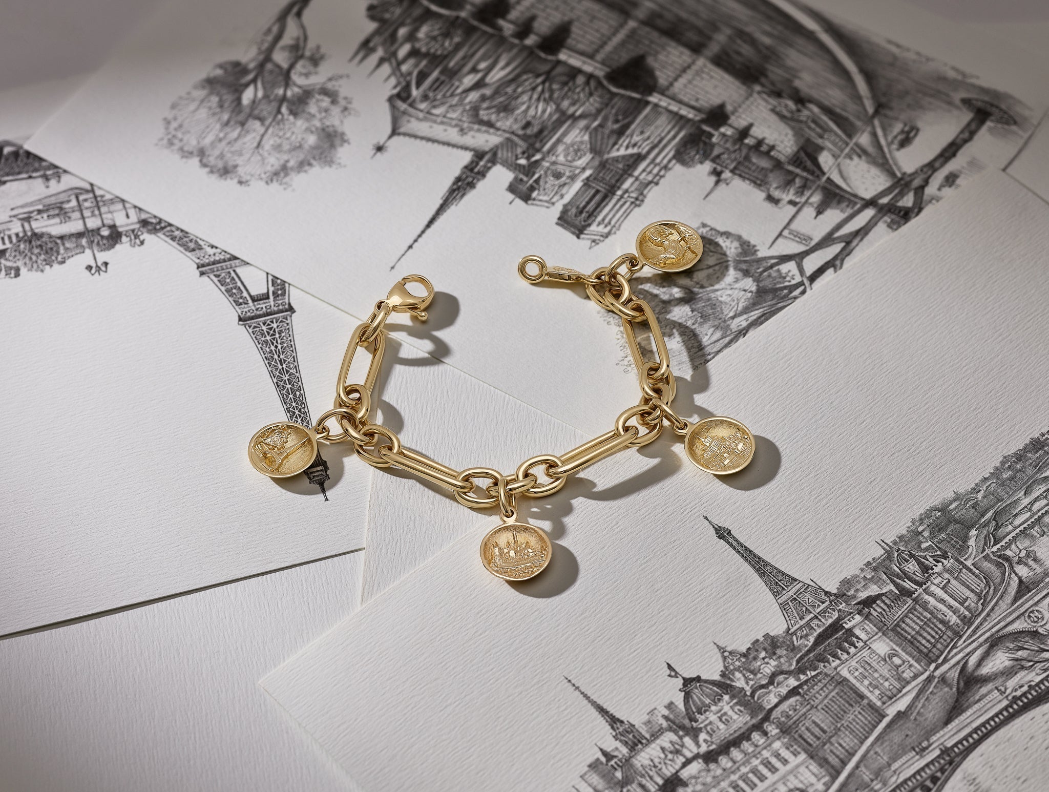 Handcrafted yellow gold bracelet with French medallions as charms.