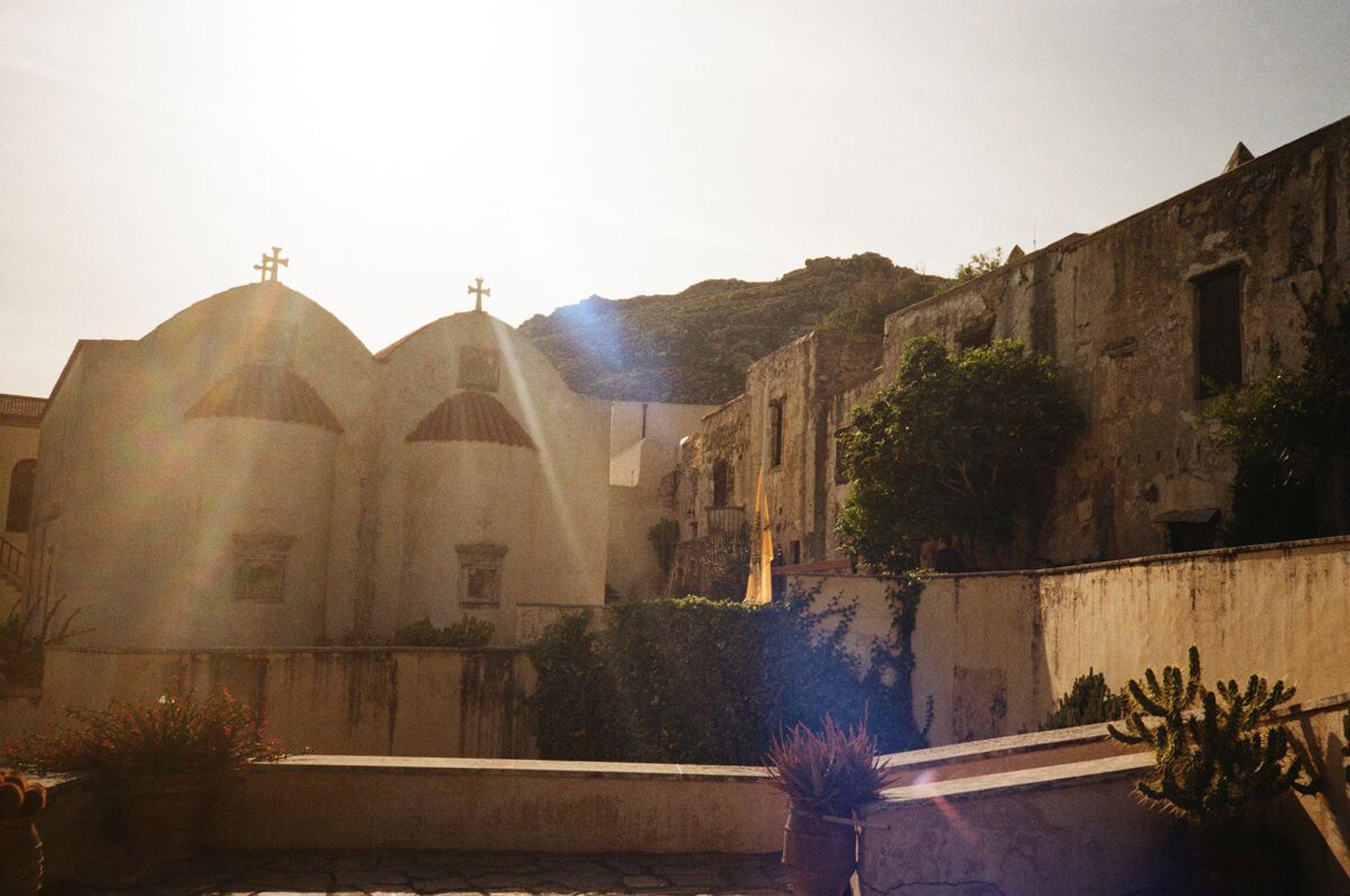 Stone exterior of Holy Monastery of Piso Preveli bathed in sun light.