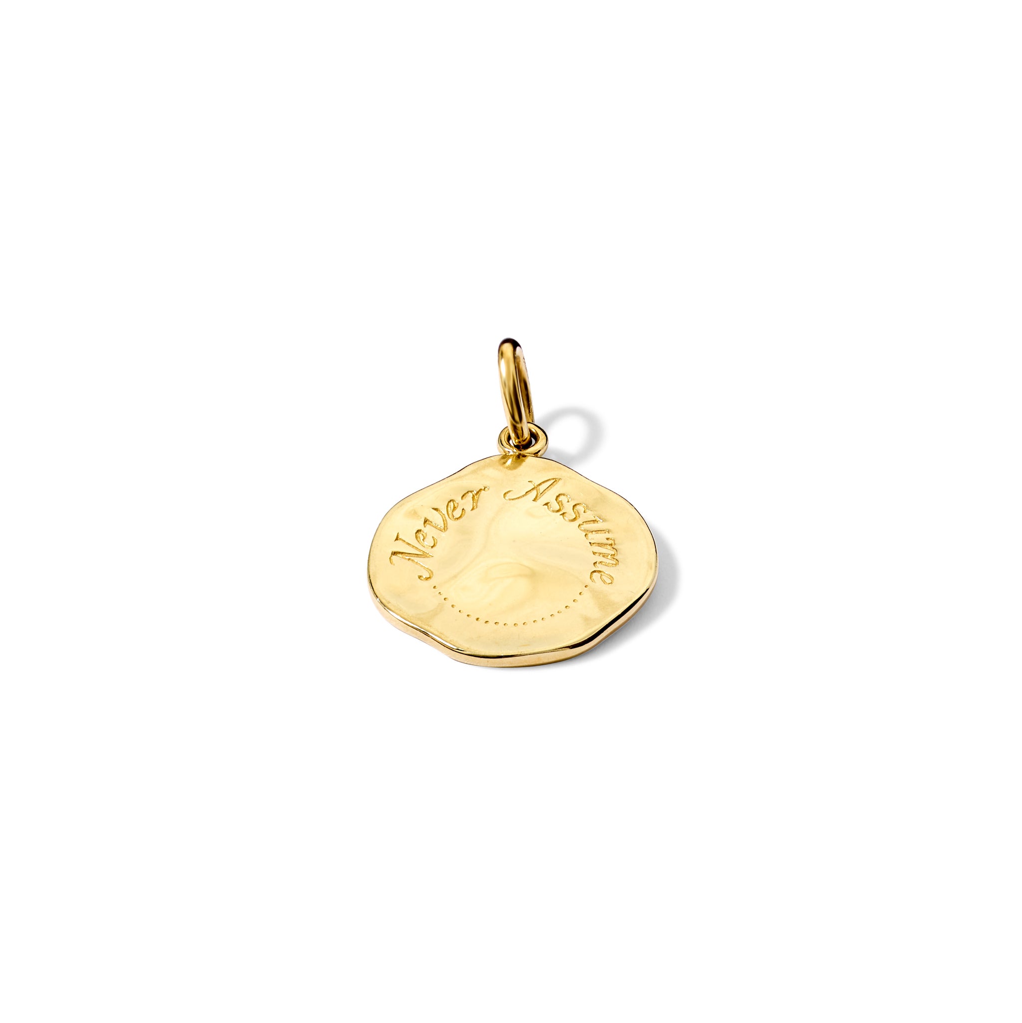 Handcrafted yellow gold necklace pendant engraved with the quote, 'Never Assume.'