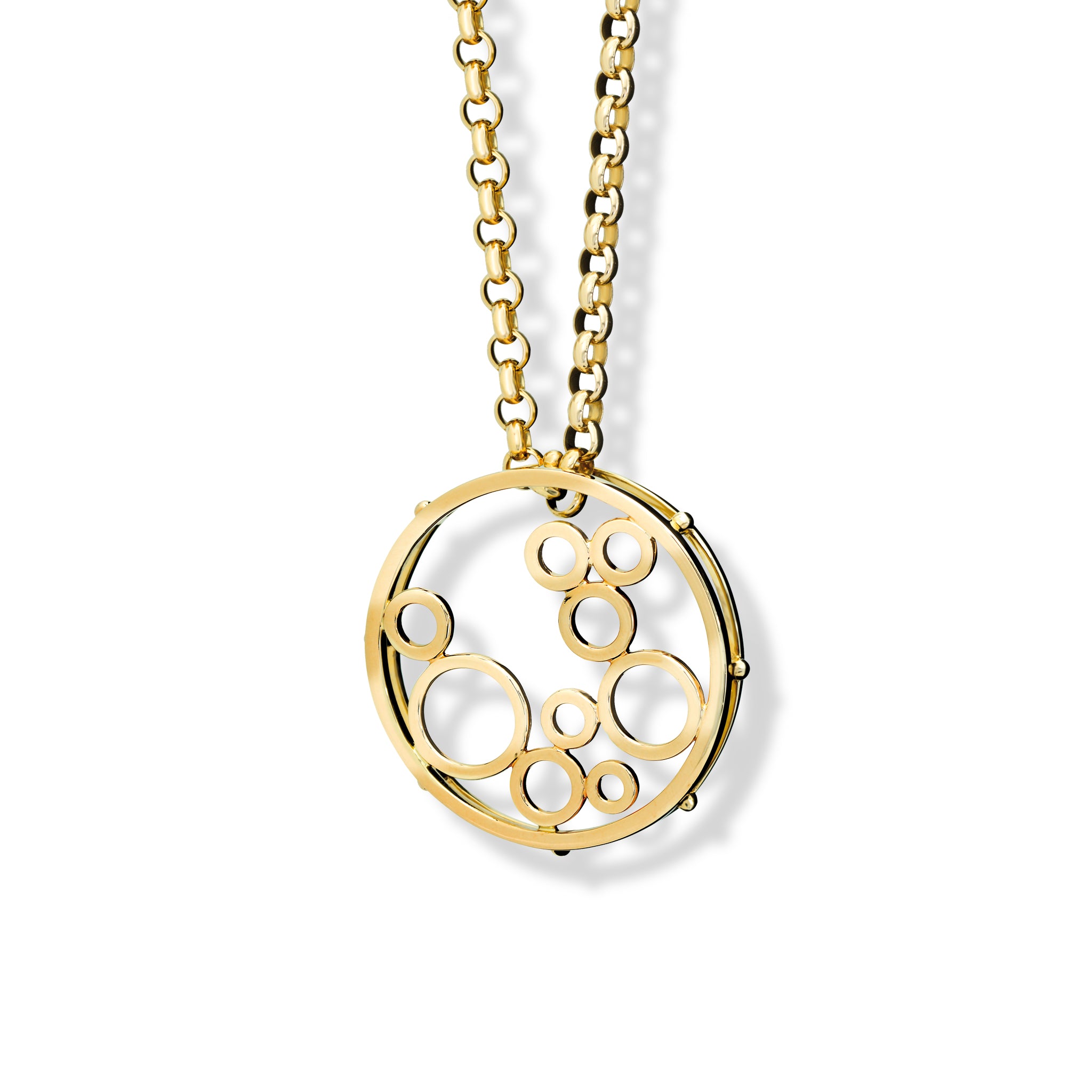 Handcrafted yellow gold necklace pendant featuring an open circular design with variously sized cut-out circles.