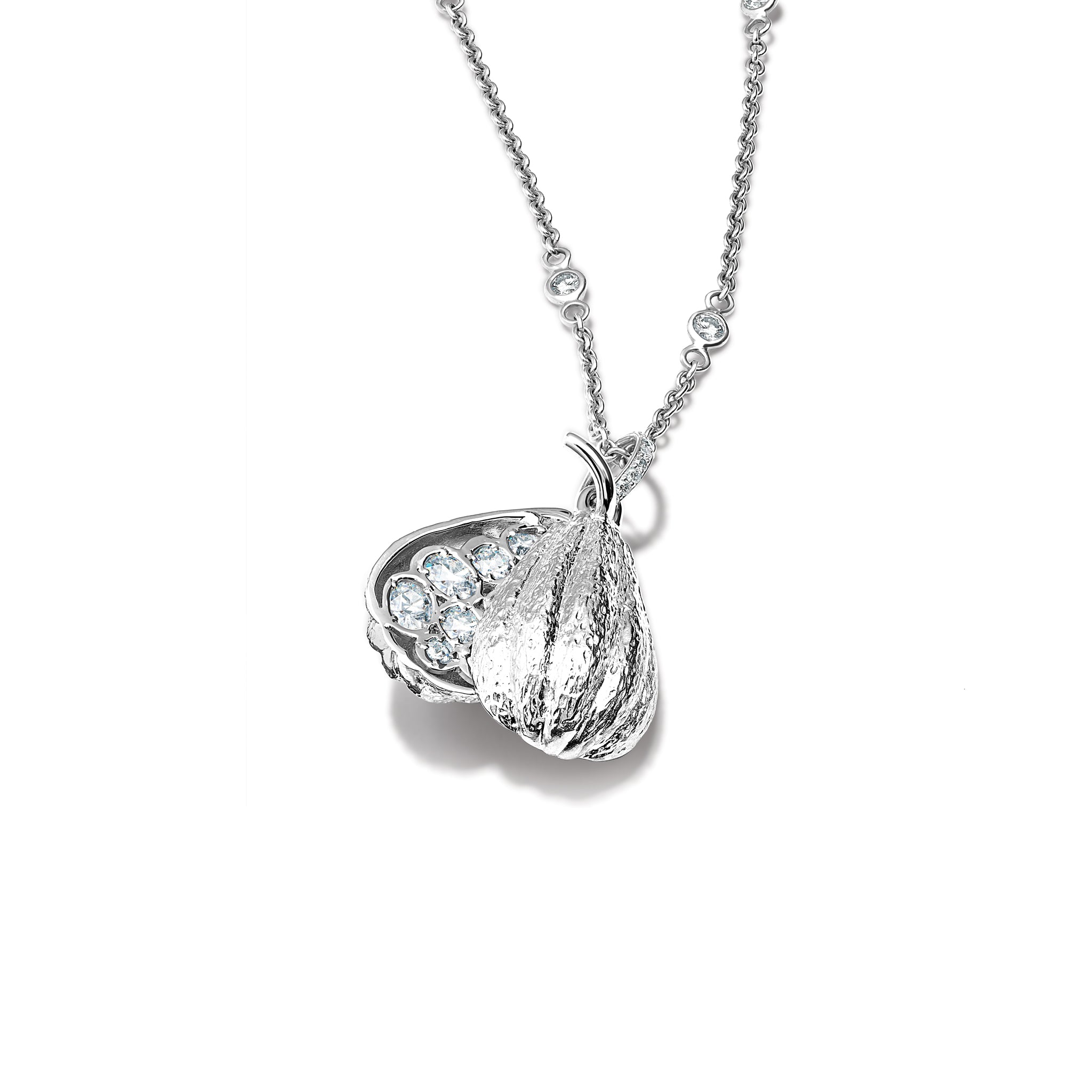 Handcrafted 18ct white gold necklace pendant shaped like a cocoa pod, revealing small diamonds nestled inside, the birthstone of April.