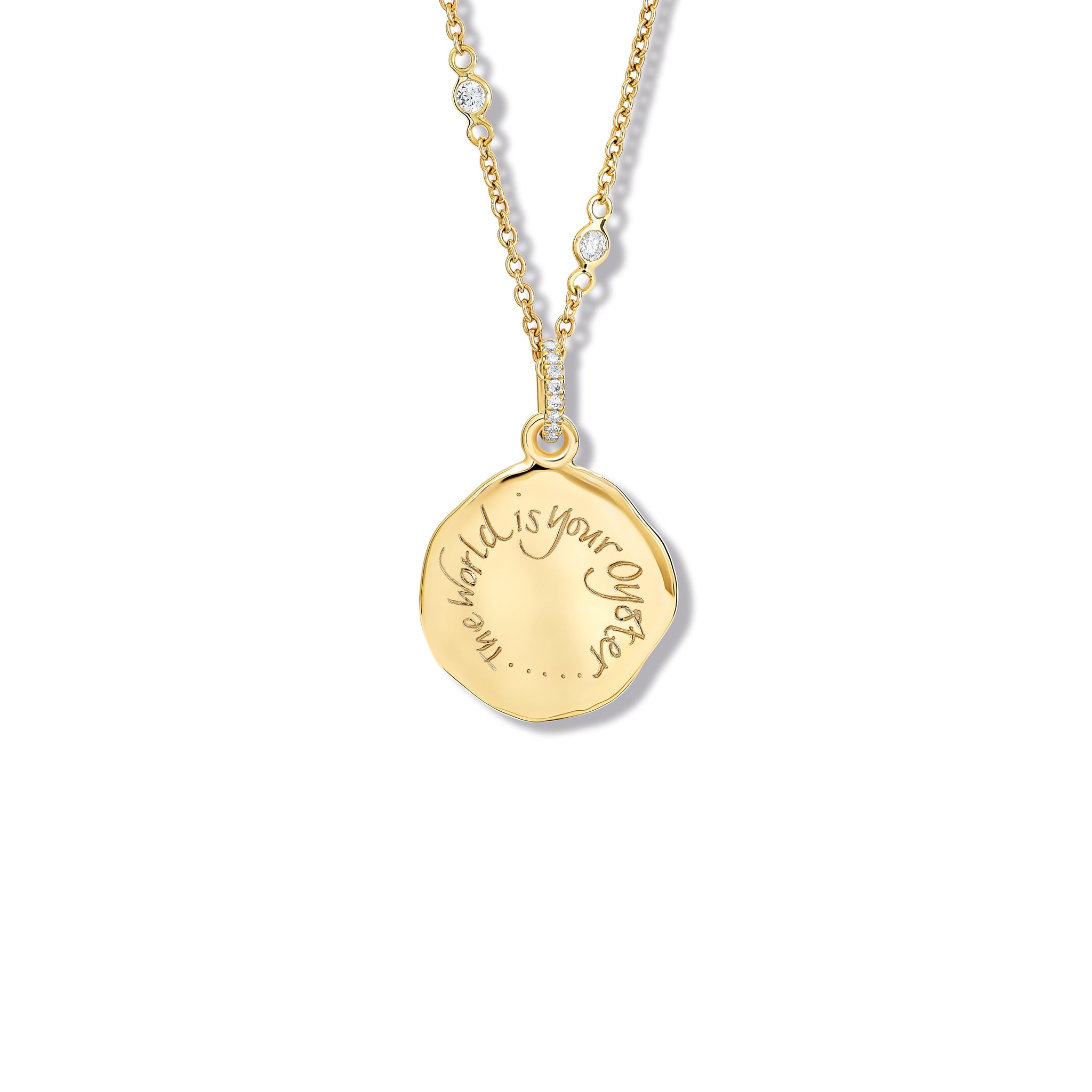 Handcrafted yellow gold round necklace pendant adorned with diamond pav? and engraved with the quote 'The world is your oyster.'