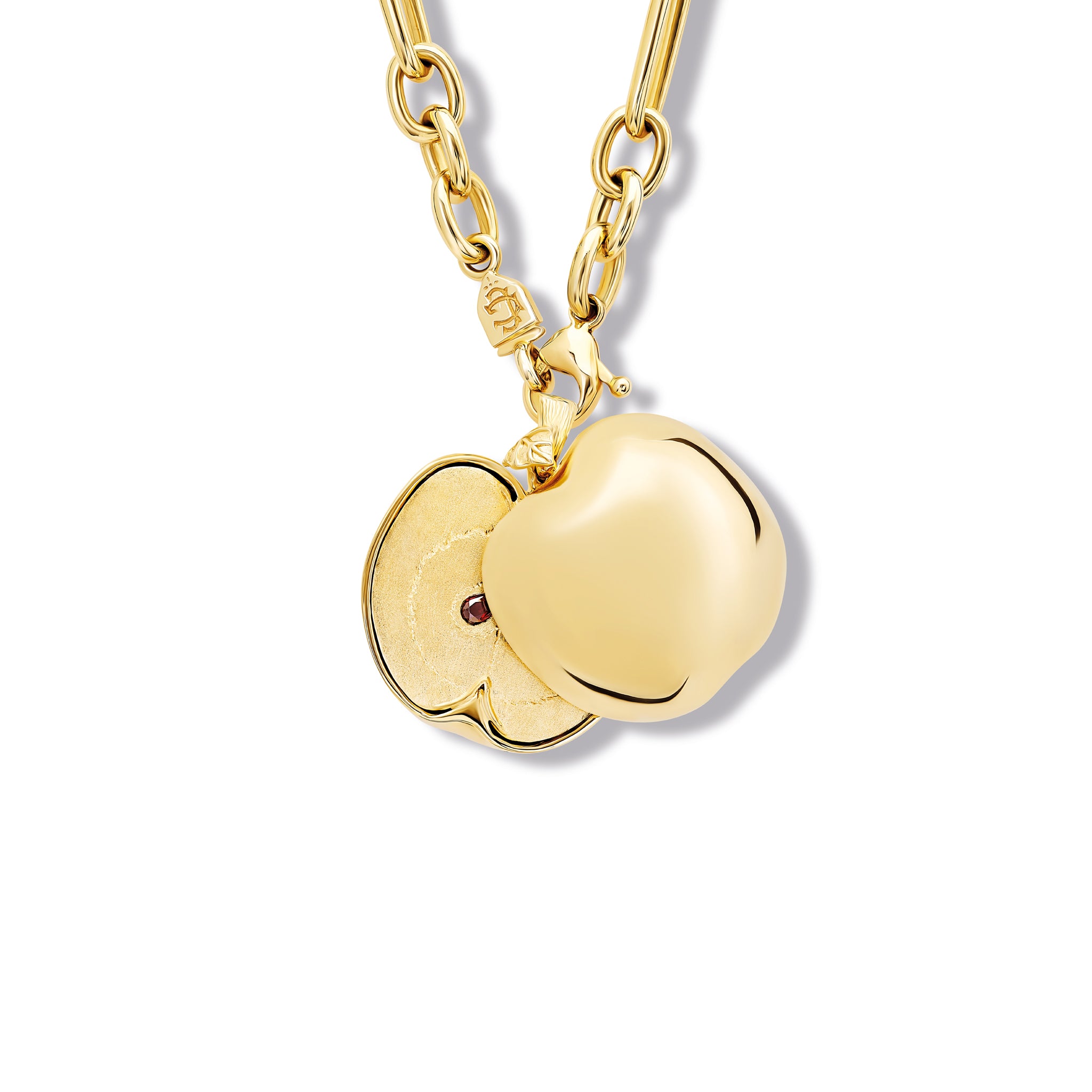 Handcrafted apple shaped necklace pendant in yellow gold that opens to reveal a central garnet gemstone.