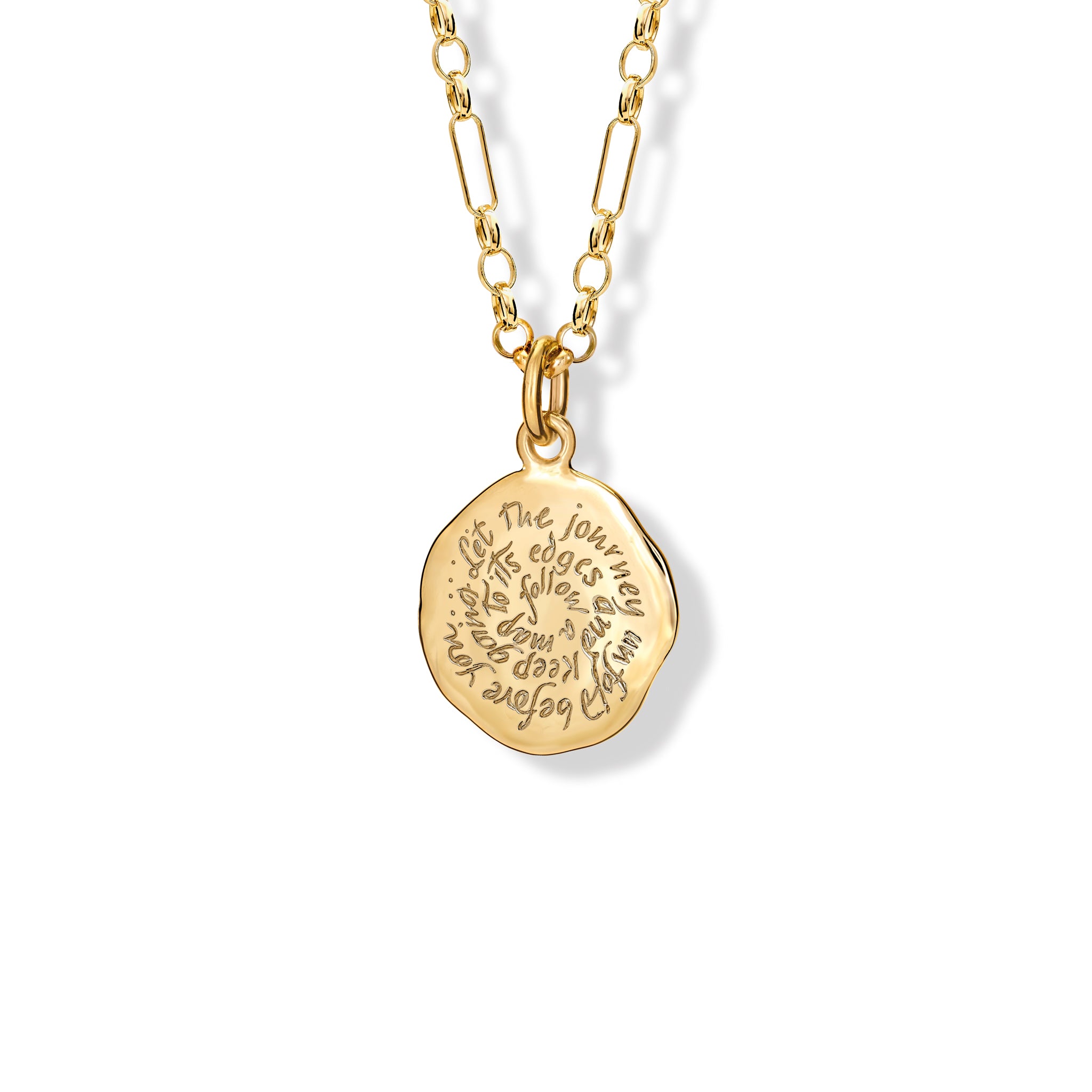 Handcrafted round yellow gold necklace pendant engraved with the quote, 'Follow a map to its edges. Let the journey unfold before you.'