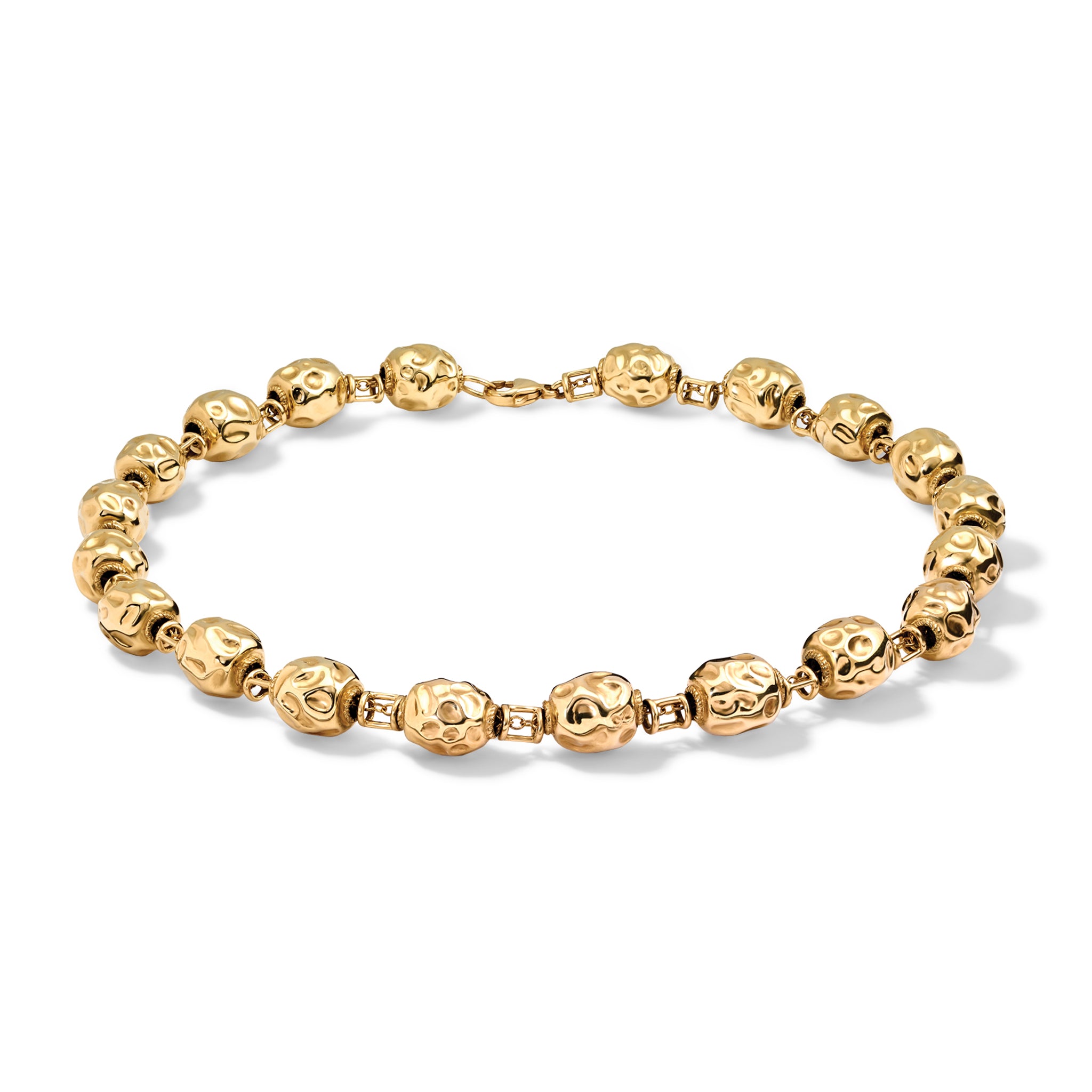 Handcrafted yellow gold necklace adorned with beads that showcase textured, uneven dimples.