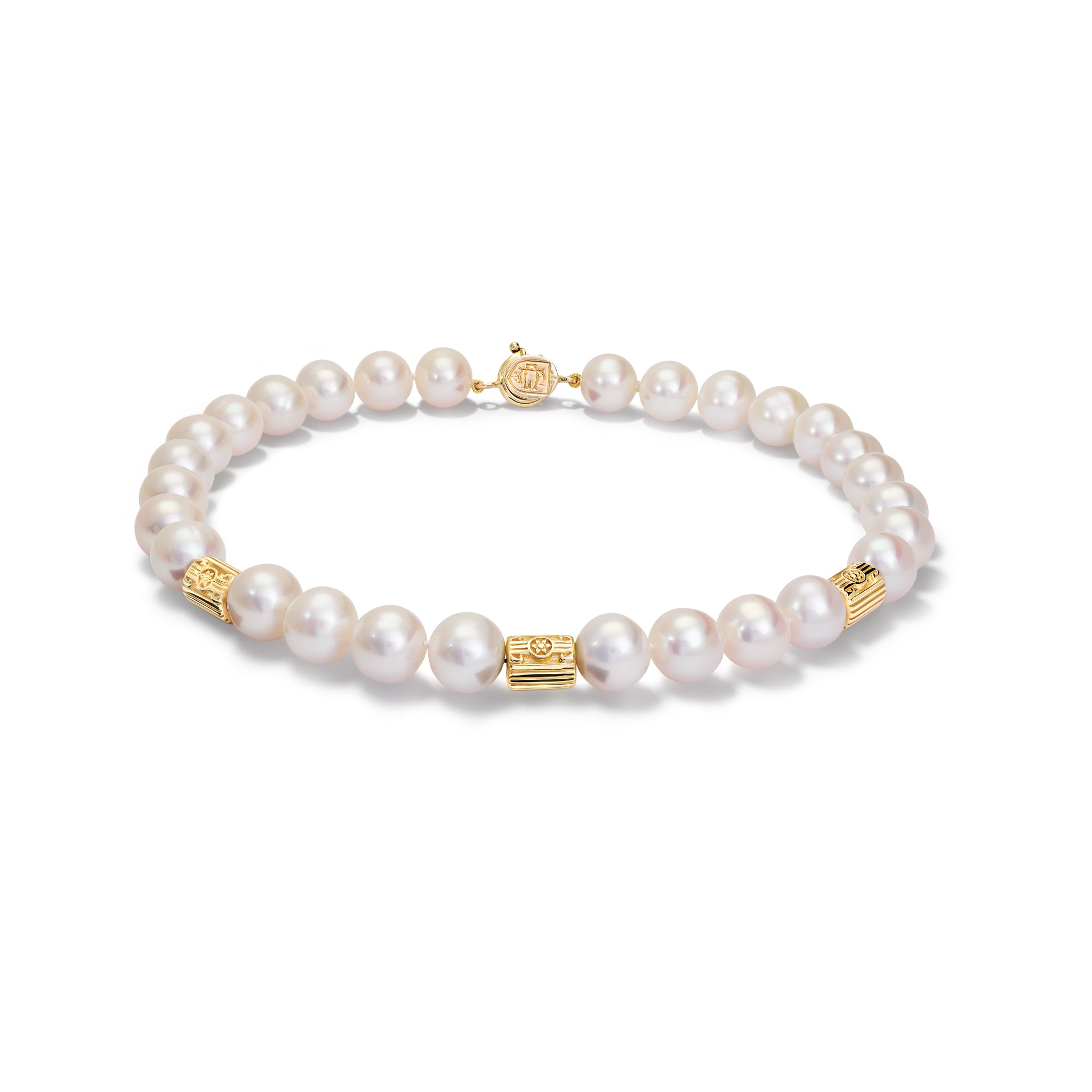 Handcrafted yellow gold necklace featuring textured column shaped spacers between pearls.