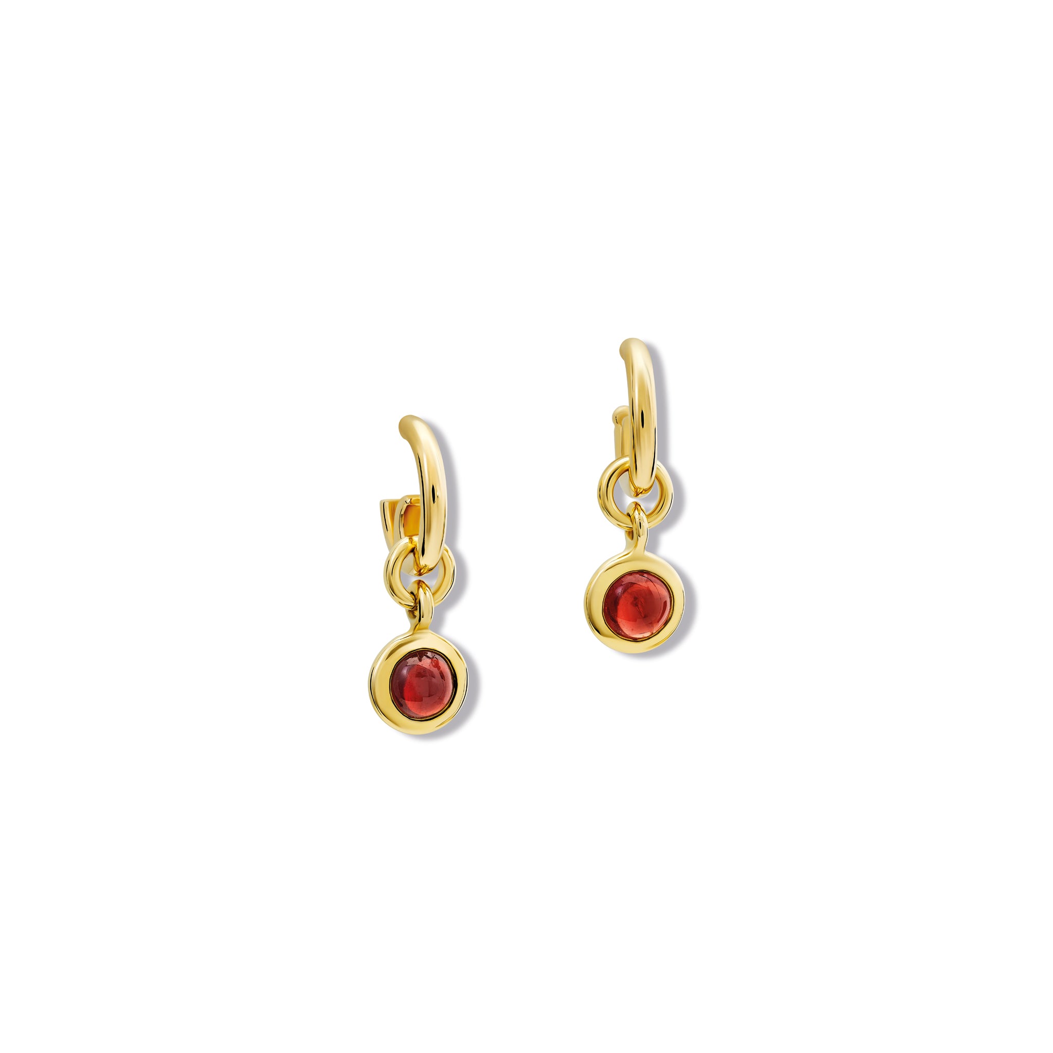 Model wearing handcrafted earring drops in precious metal with round precious stones.