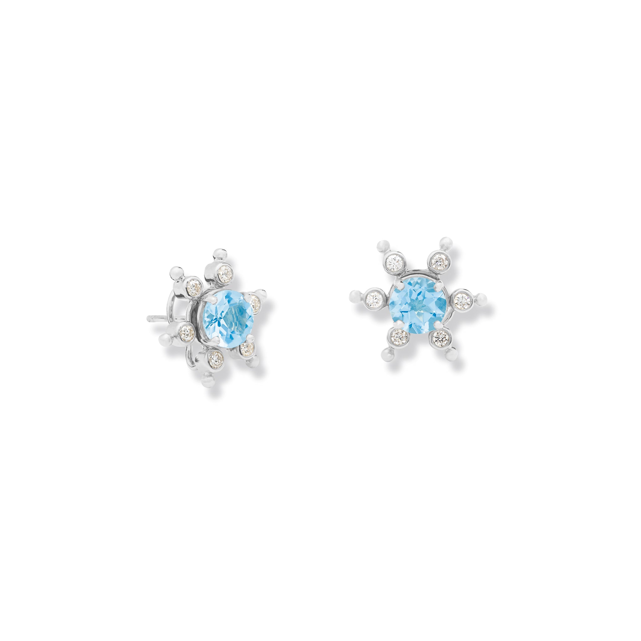 Handcrafted white gold earring halos inspired by a cactus, featuring six prongs, each set with a small diamond.