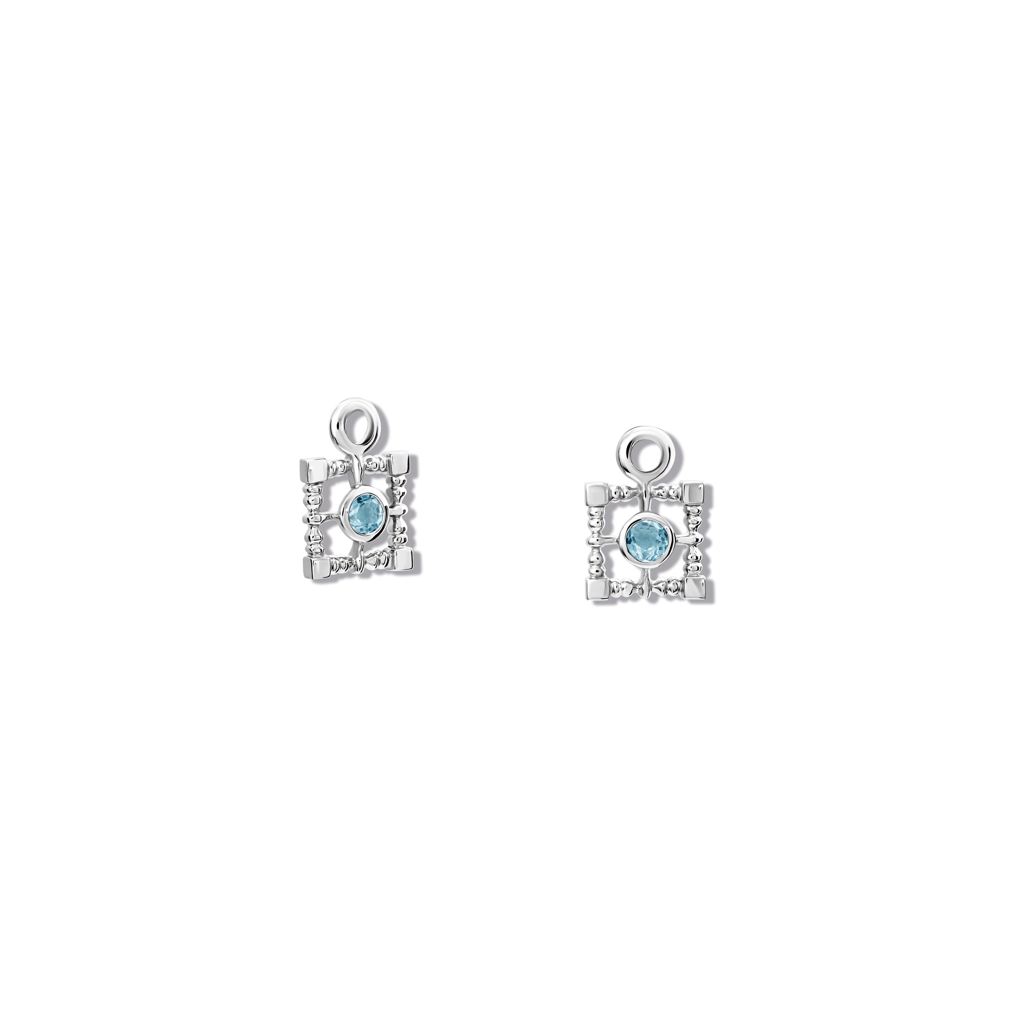 Handcrafted silver earring drops featuring a teardrop-shaped design with blue topaz, birthstone of November.