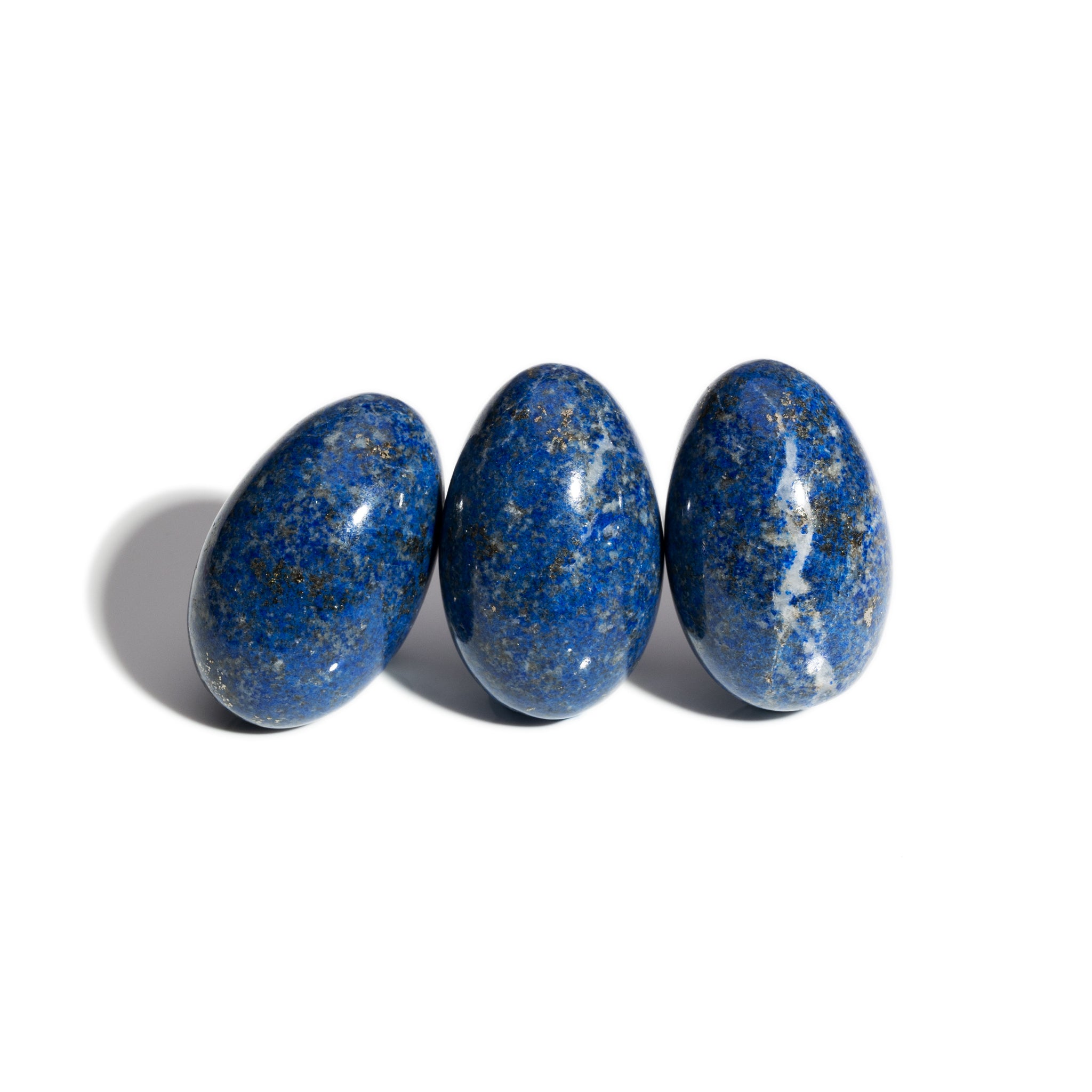 Three handcrafted gemstone eggs in the precious stone lapis lazuli.