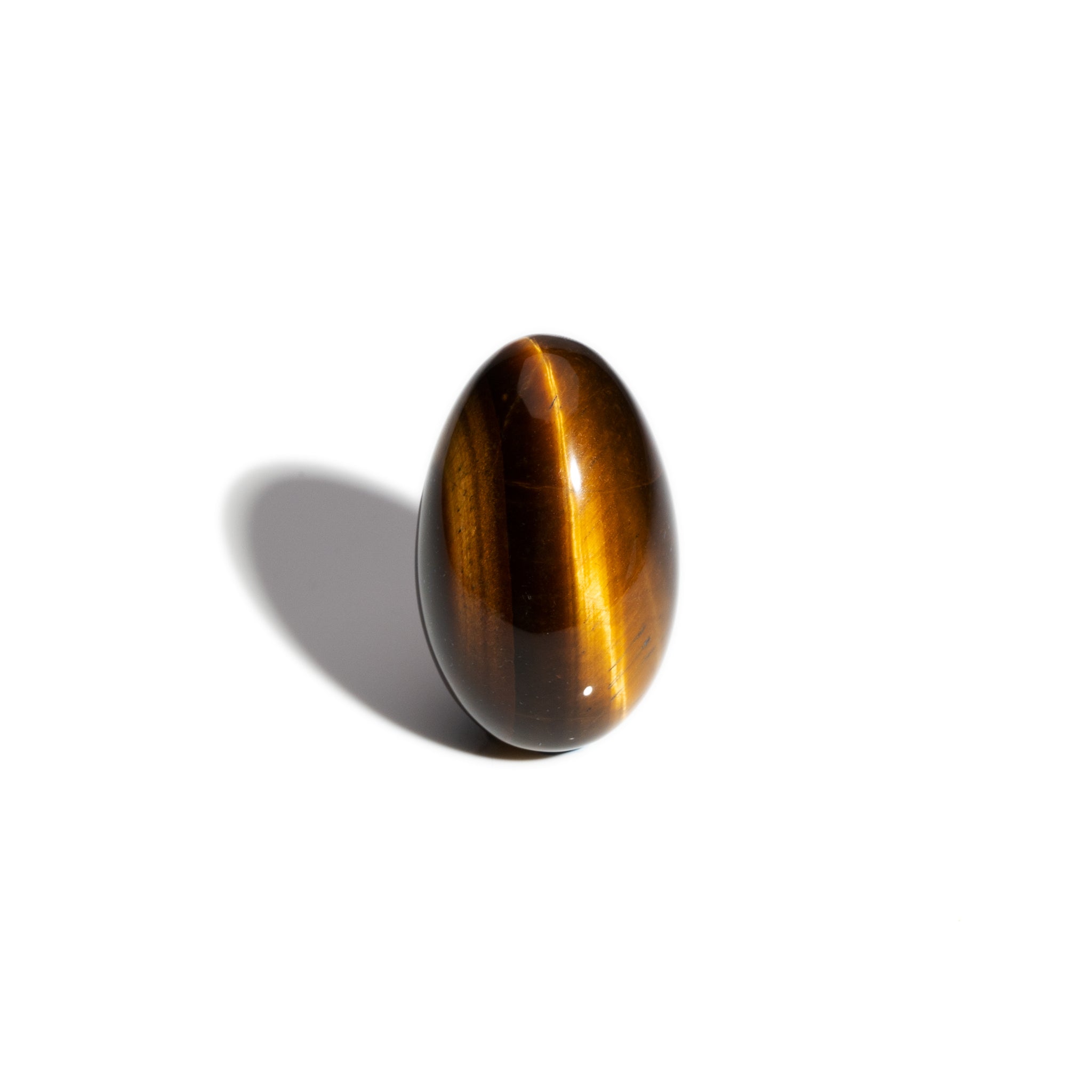 A handcrafted gemstone egg in the precious stone tiger's eye.