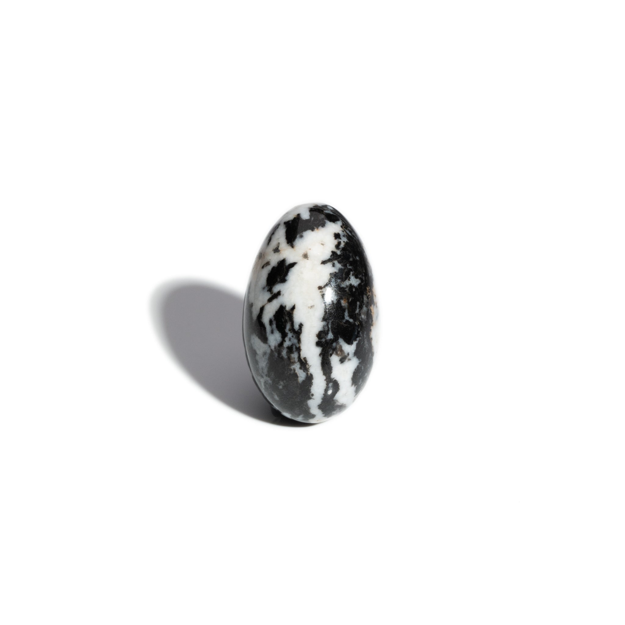 A handcrafted gemstone egg in the precious stone zebra jasper.