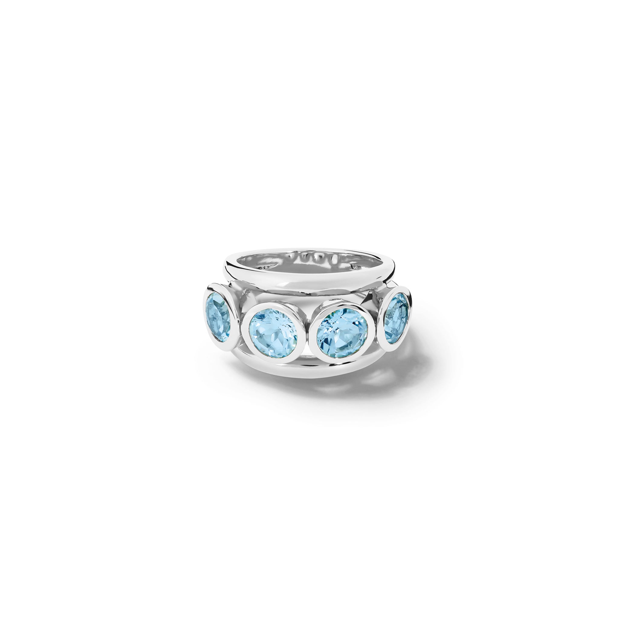 Handcrafted precious metal ring with a bold band and five circular blue topaz gemstones, birthstone of November, in bezel settings.
