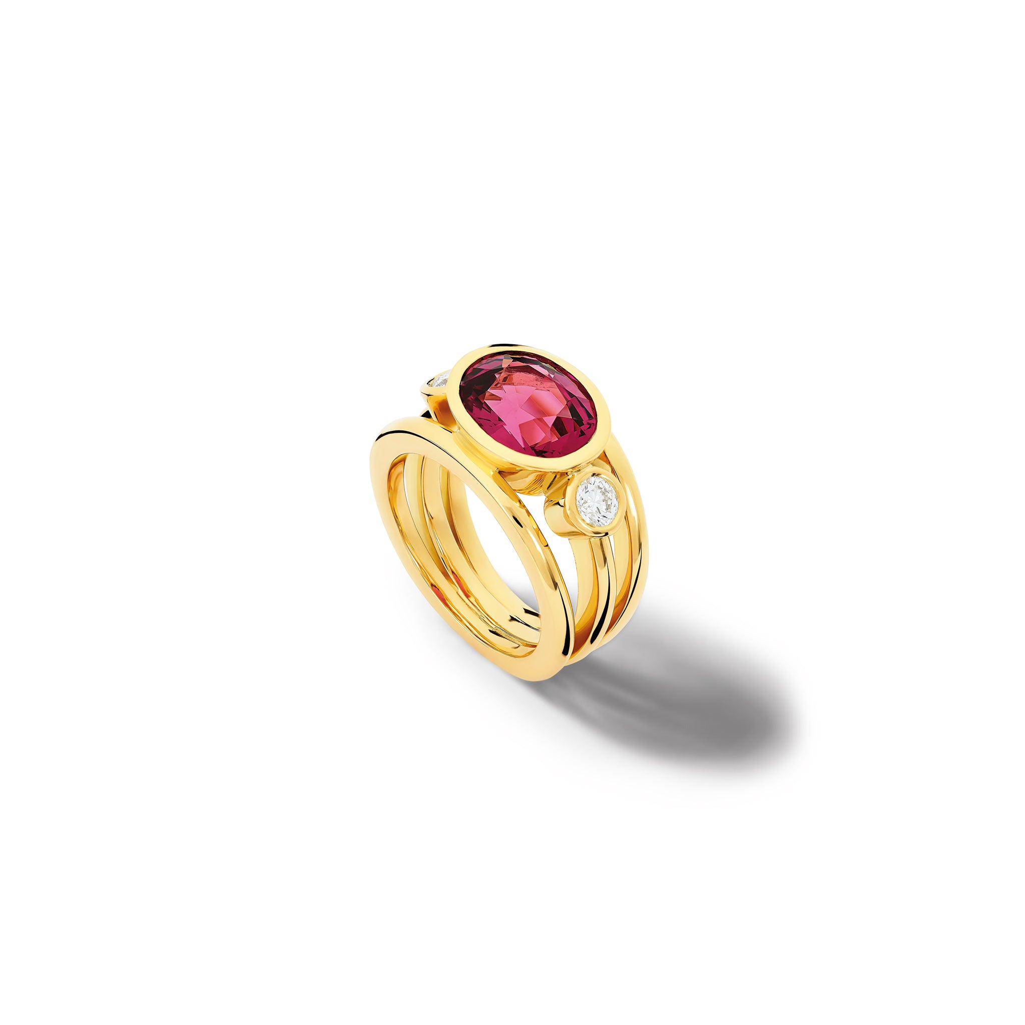 Handcrafted 18ct yellow gold ring with a central pink umbilite garnet, the birthstone of January, flanked by two round diamonds.