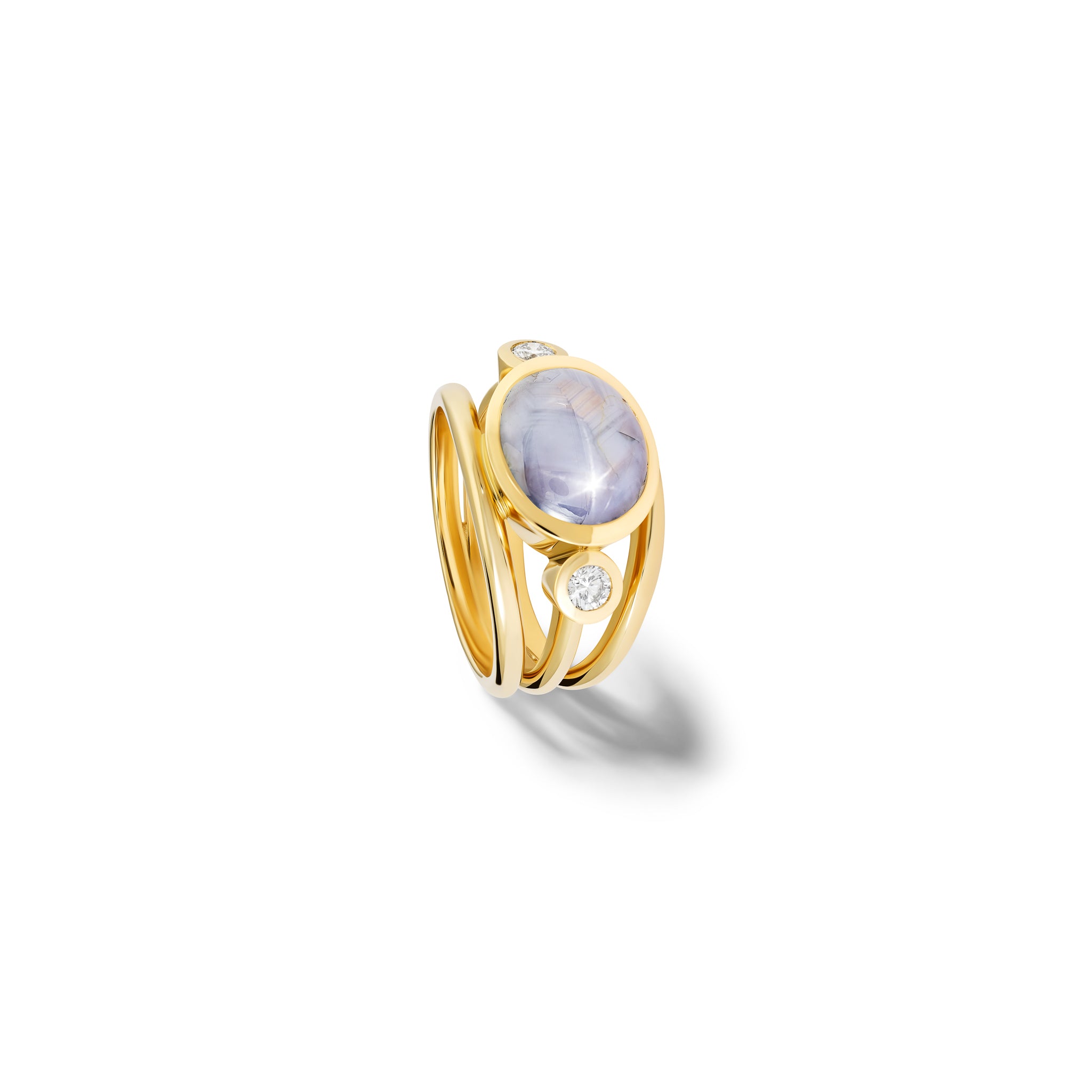 Handcrafted 18ct yellow gold ring with a central pale star sapphire, the birthstone of September, flanked by two round diamonds.
