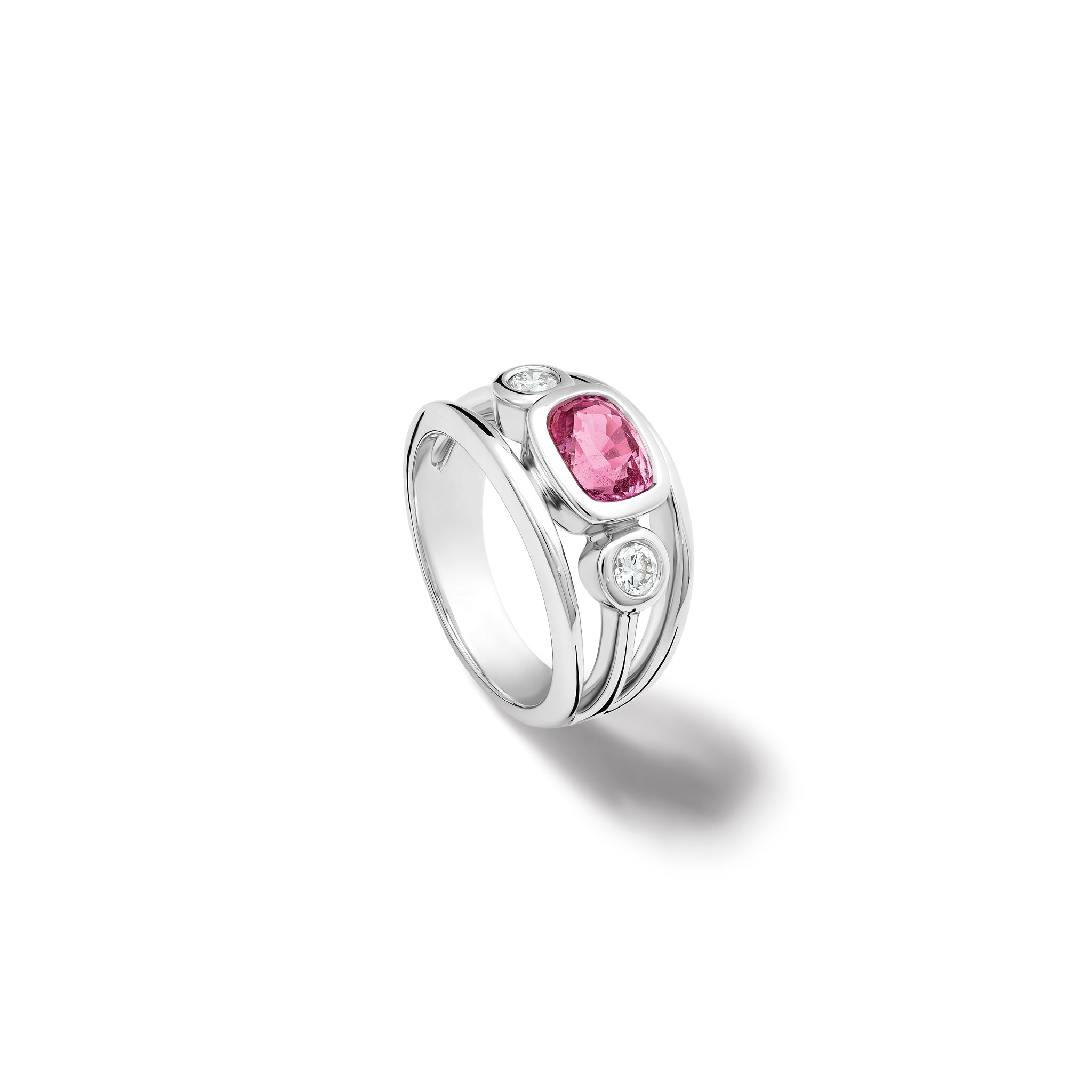 Handcrafted 18ct white gold ring with an oval pink sapphire, the birthstone of September, flanked by two round diamonds.