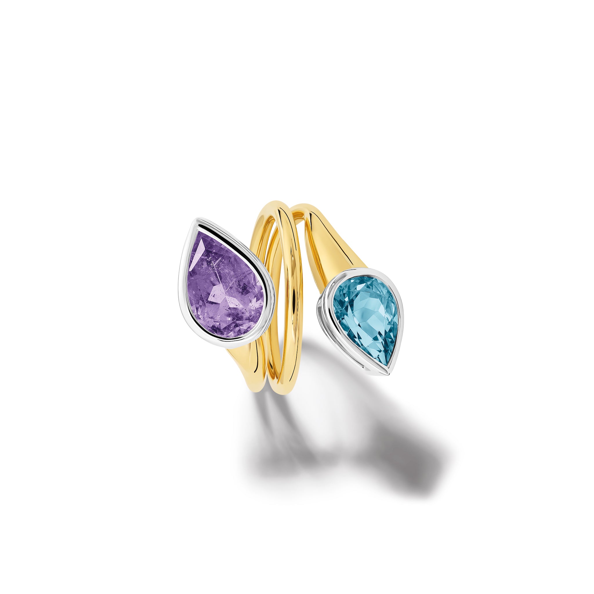 Handcrafted 18ct yellow and white gold swirl ring featuring teardrop shaped purple tourmaline and aquamarine at each end.