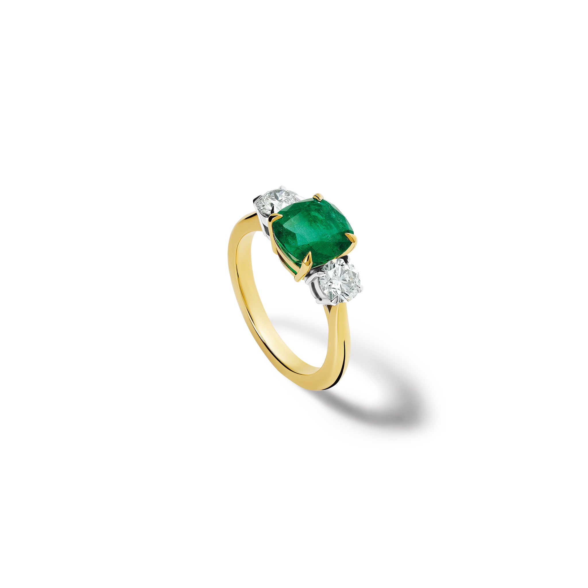 Handmade 18ct yellow gold engagement ring featuring a large, cushion cut emerald at its centre, surrounded by two smaller teardrop-shaped white diamonds.