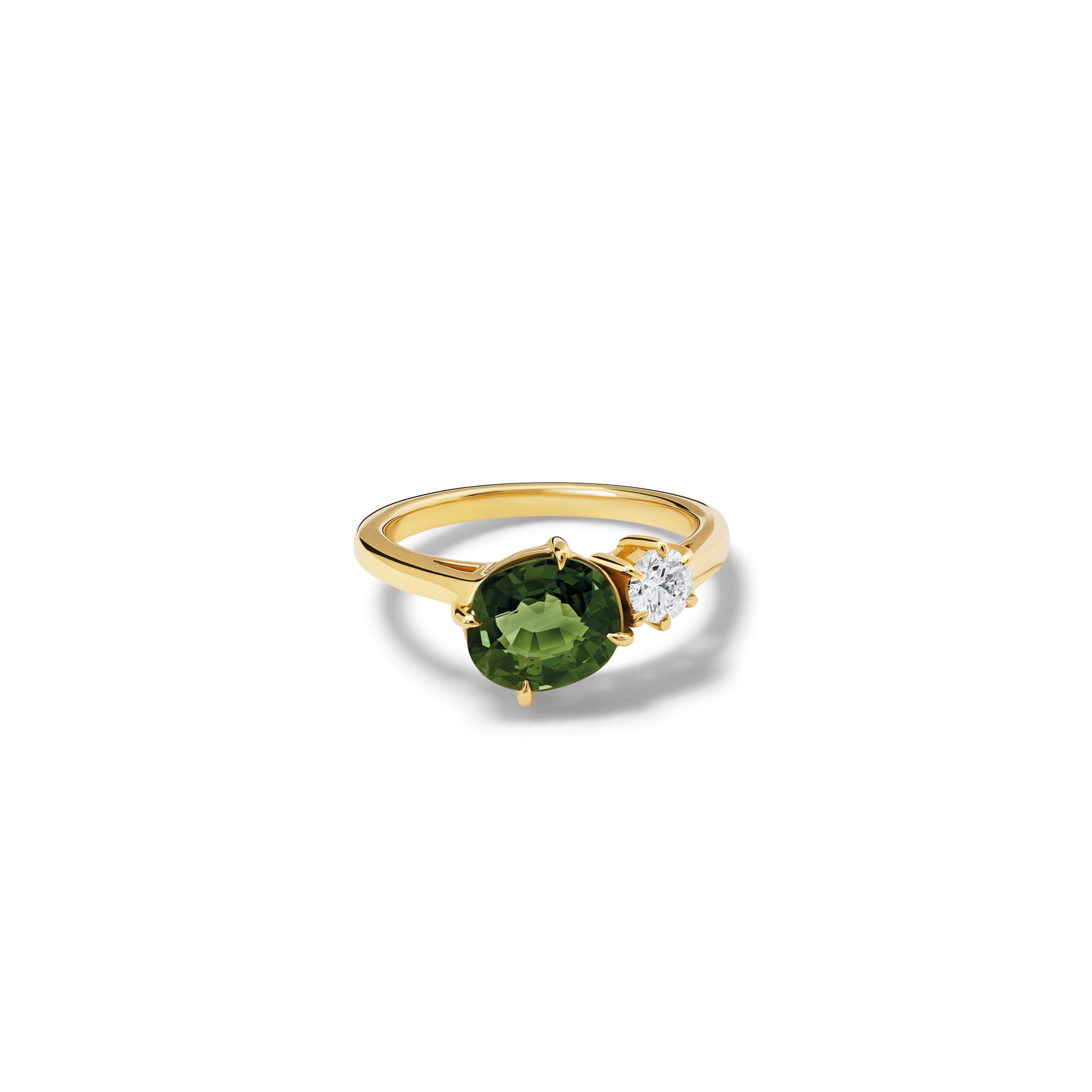 Handcrafted 18ct yellow gold engagement ring featuring two prominent stones: an oval green sapphire on the left and a round diamond on the right.