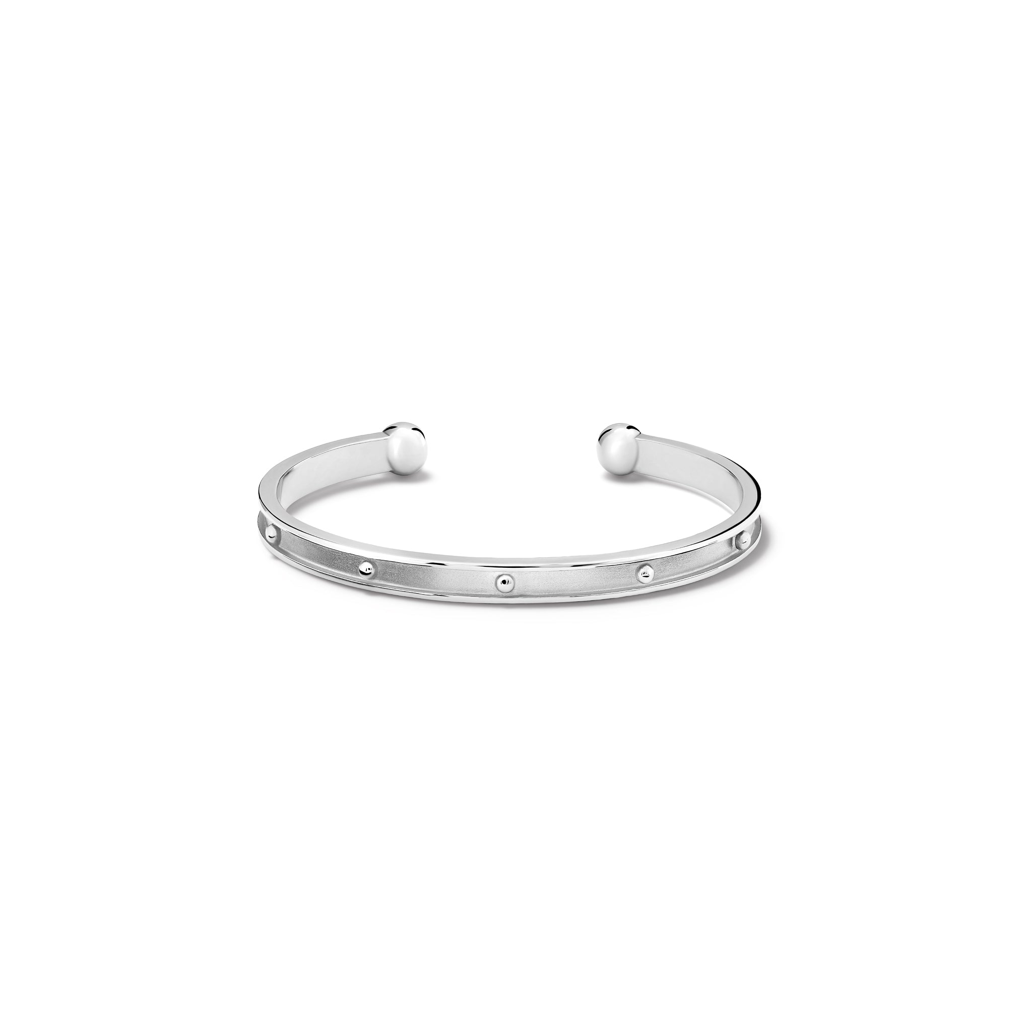 Handcrafted sterling silver bracelet cuff with evenly spaced, protruding round dots.