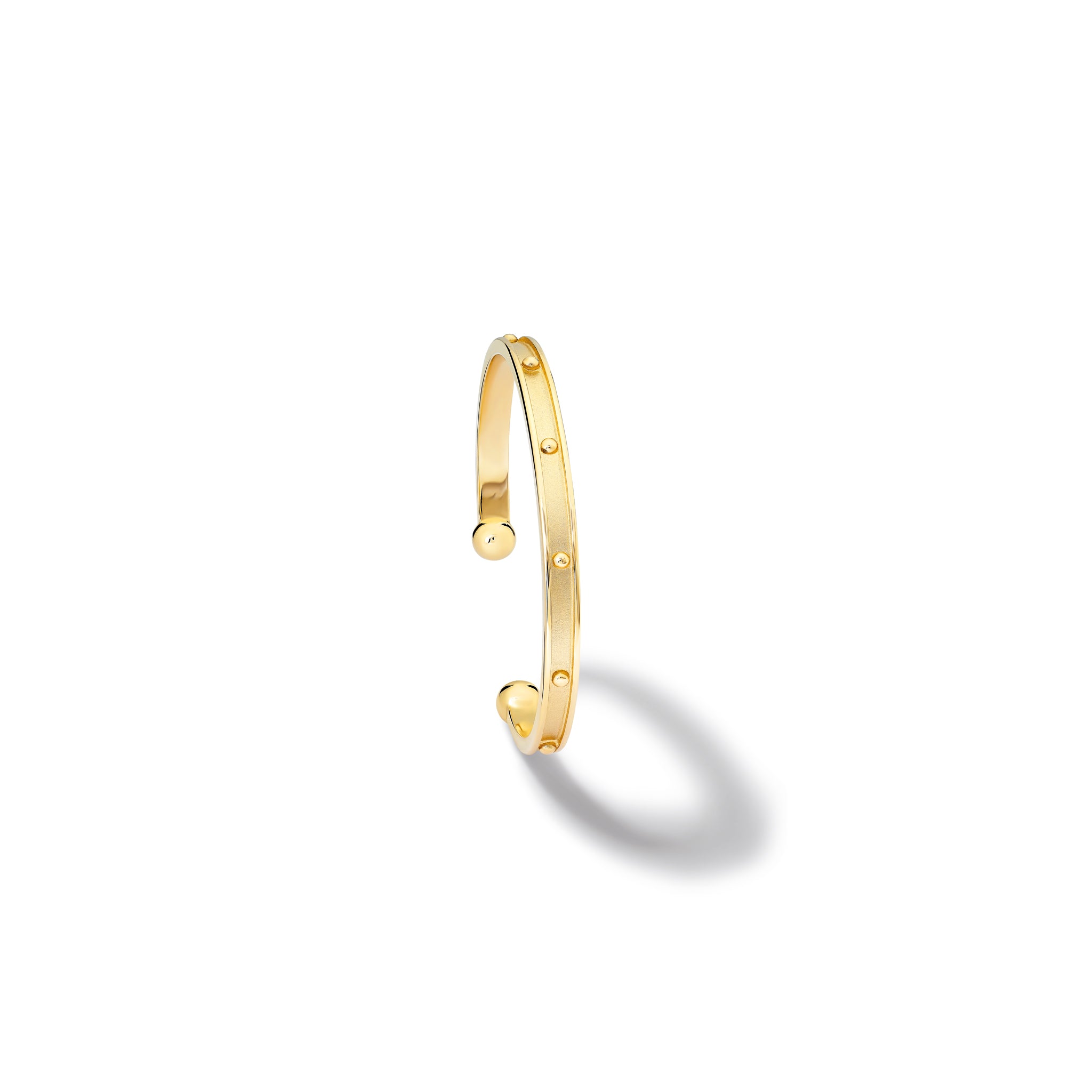 Handcrafted 18ct yellow gold bracelet cuff with evenly spaced, protruding round dots.