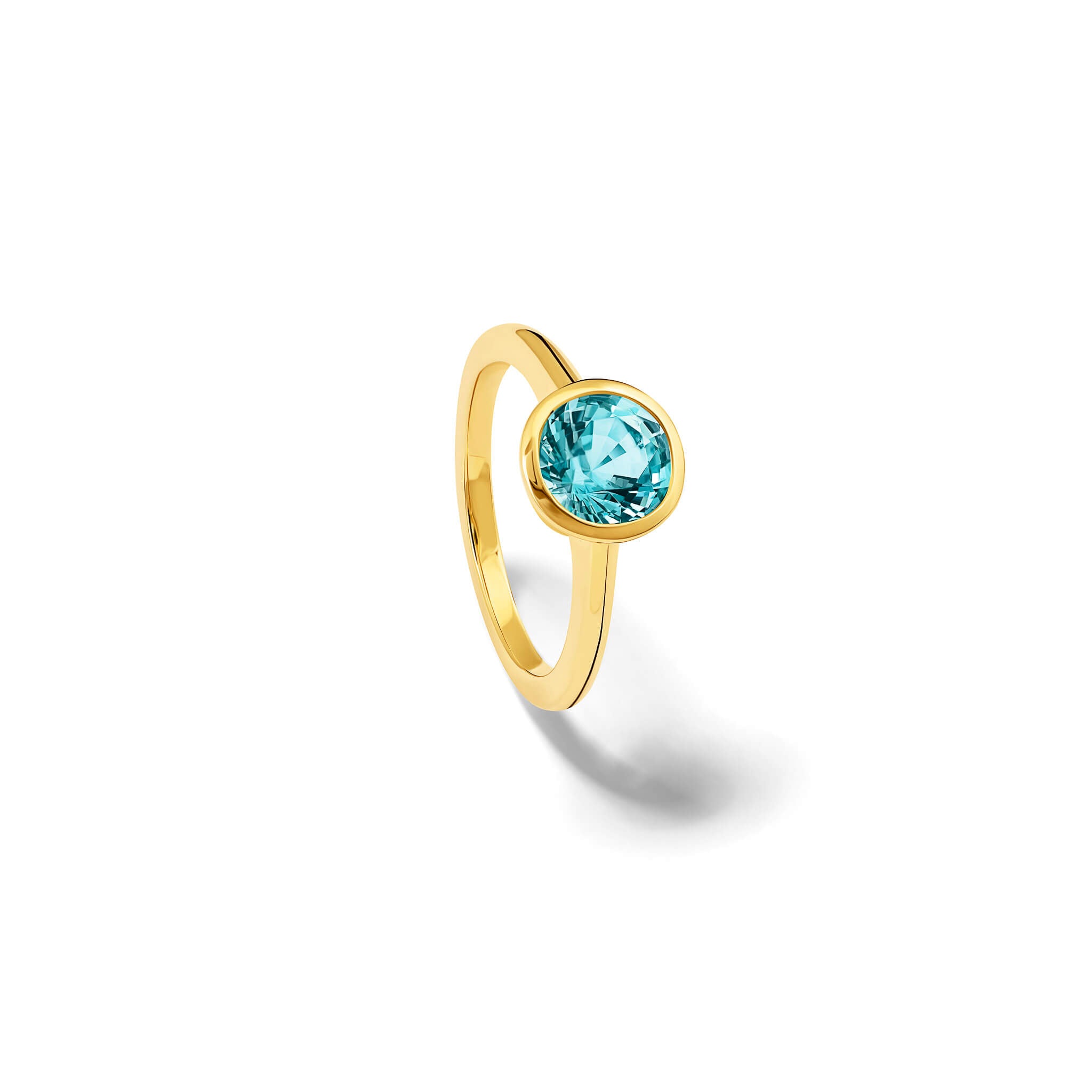 Handmade 18ct yellow gold engagement ring featuring a round central aquamarine in a rub over setting.