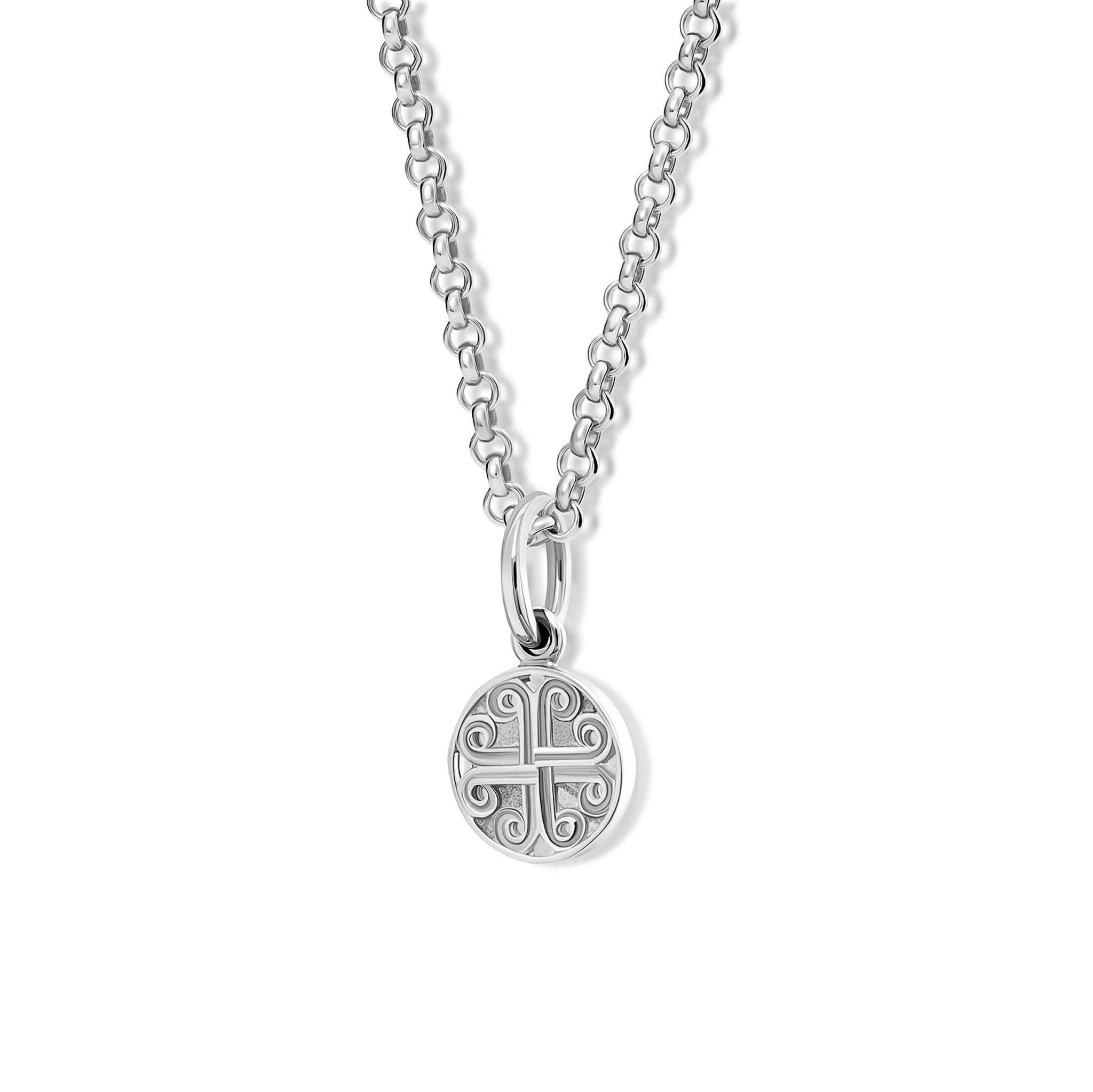 The handcrafted Kefalonia necklace pendant in silver. A circular shaped necklace pendant with a cross-like motif in the centre.