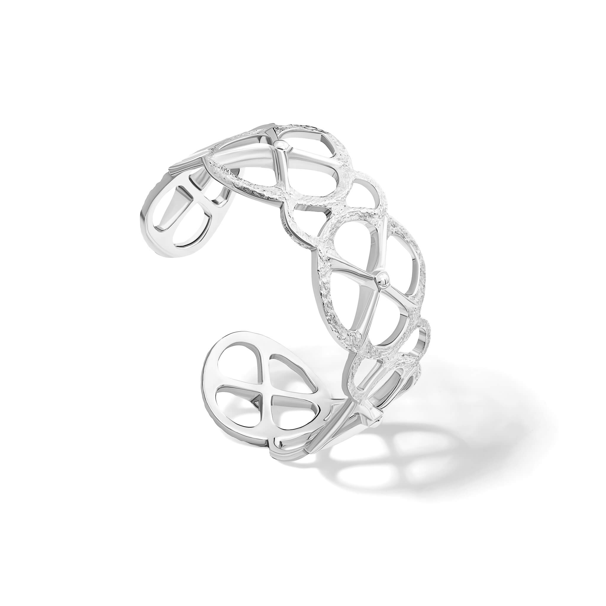 Handcrafted sterling silver cuff bracelet with a circular motif and a cross in the middle.