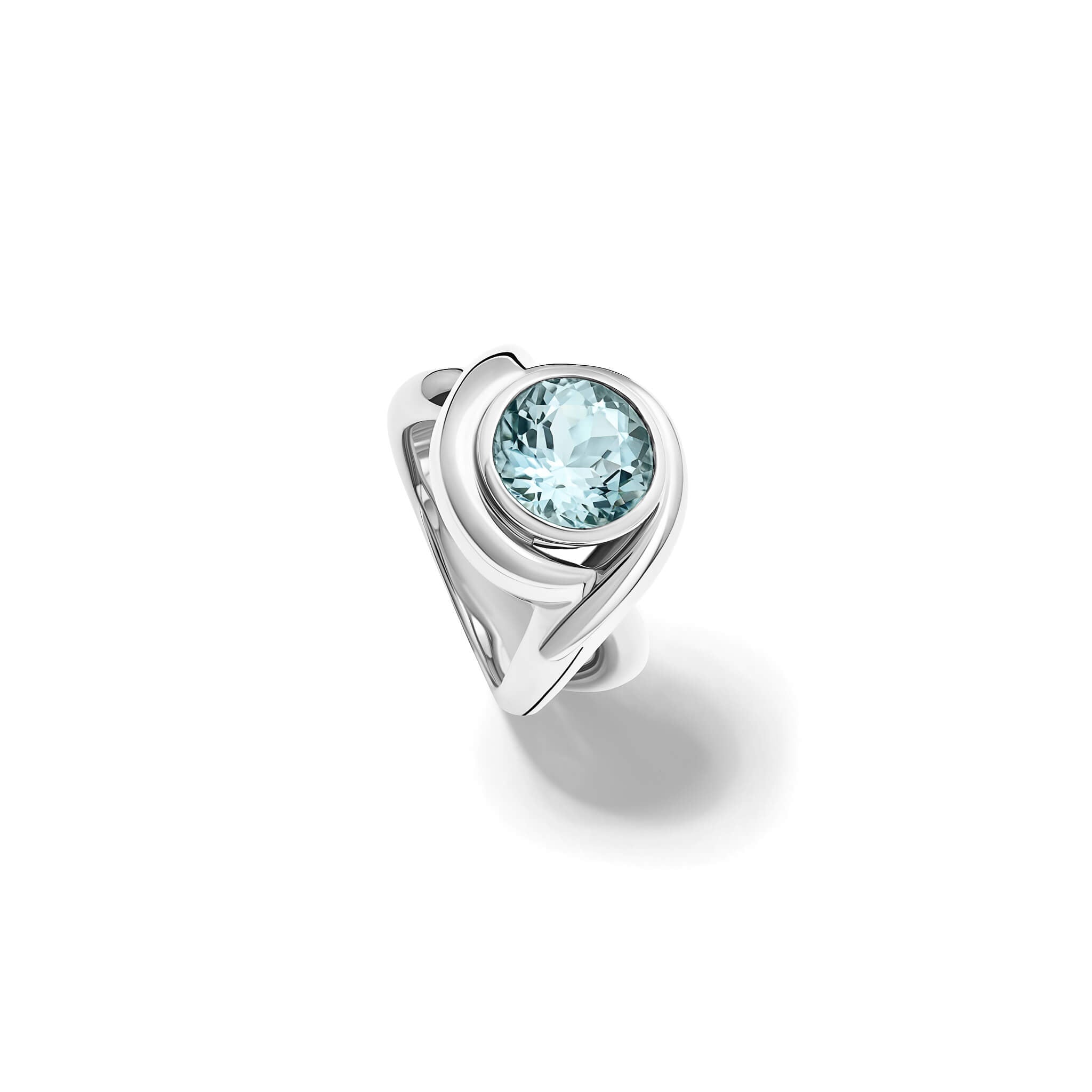 Handcrafted silver ring featuring curved shanks with a round blue topaz, birthstone of November.