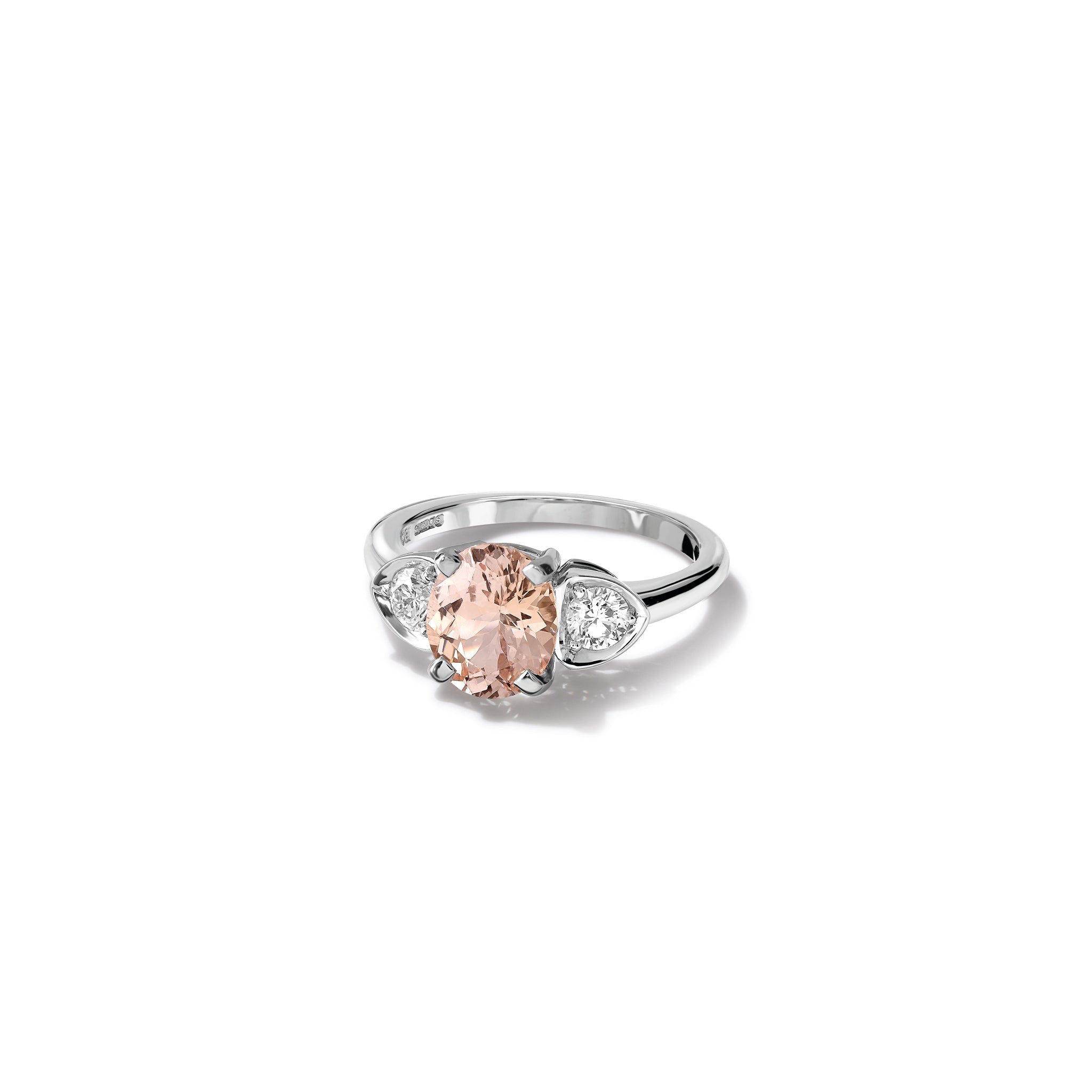 Handcrafted 18ct white gold engagement ring featuring a large central oval light pink sapphire flanked by one smaller teardrop-shaped diamond on each side.