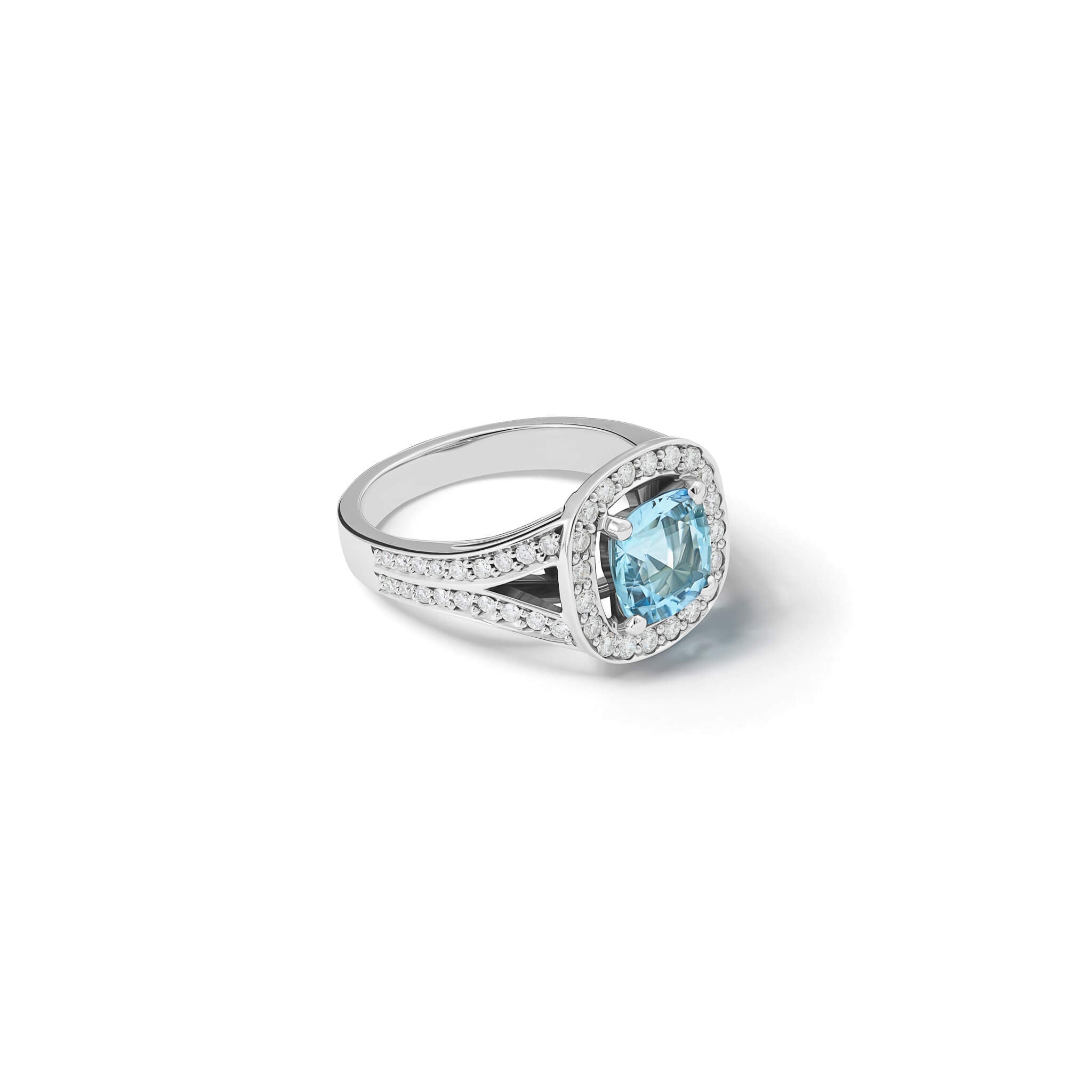 Handcrafted 18ct white gold engagement ring featuring a claw set cushion-cut aquamarine surrounded by a halo of small diamonds and smaller diamonds embedded along the band.