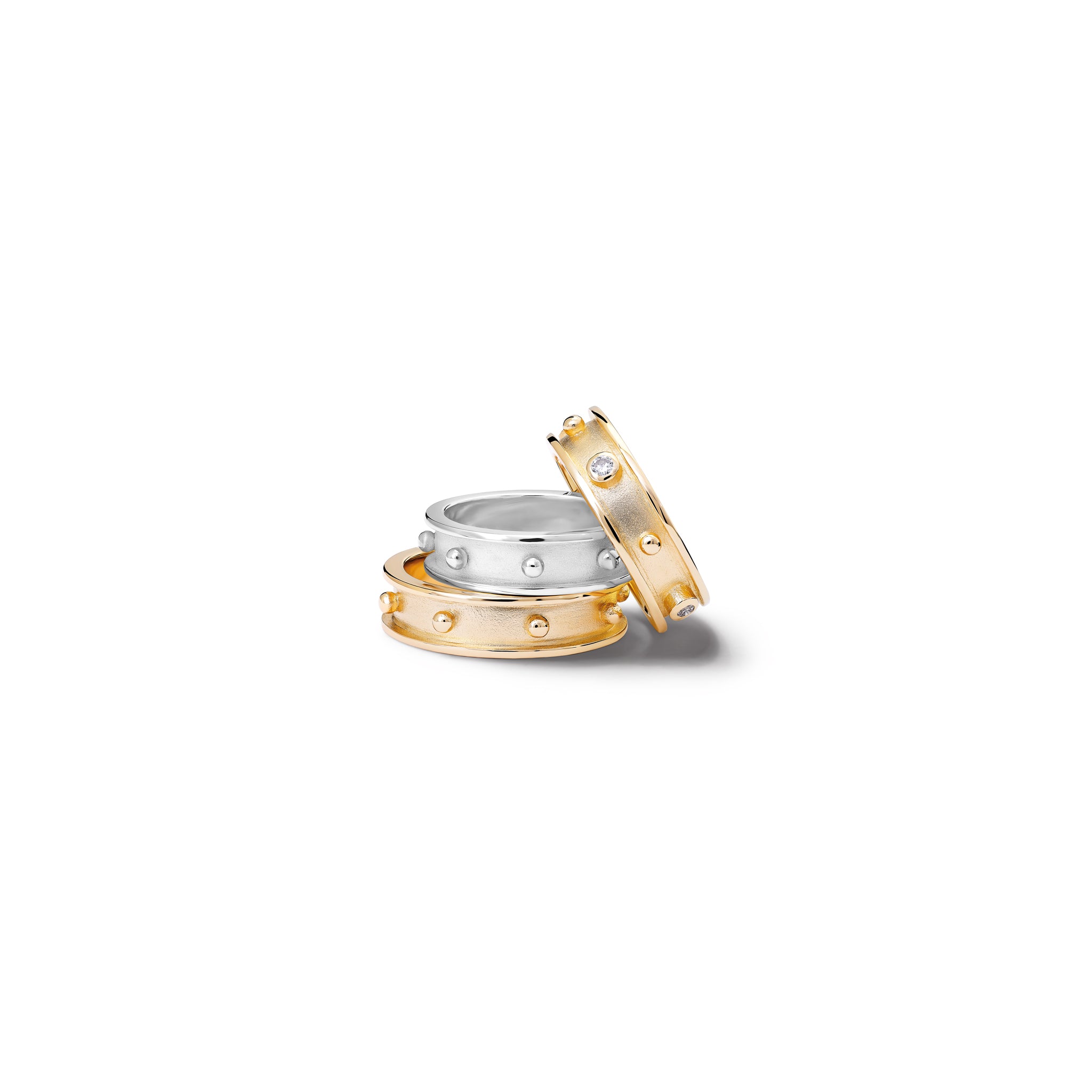 Handcrafted 18ct yellow gold and silver rings with evenly spaced, protruding round dots with diamond.