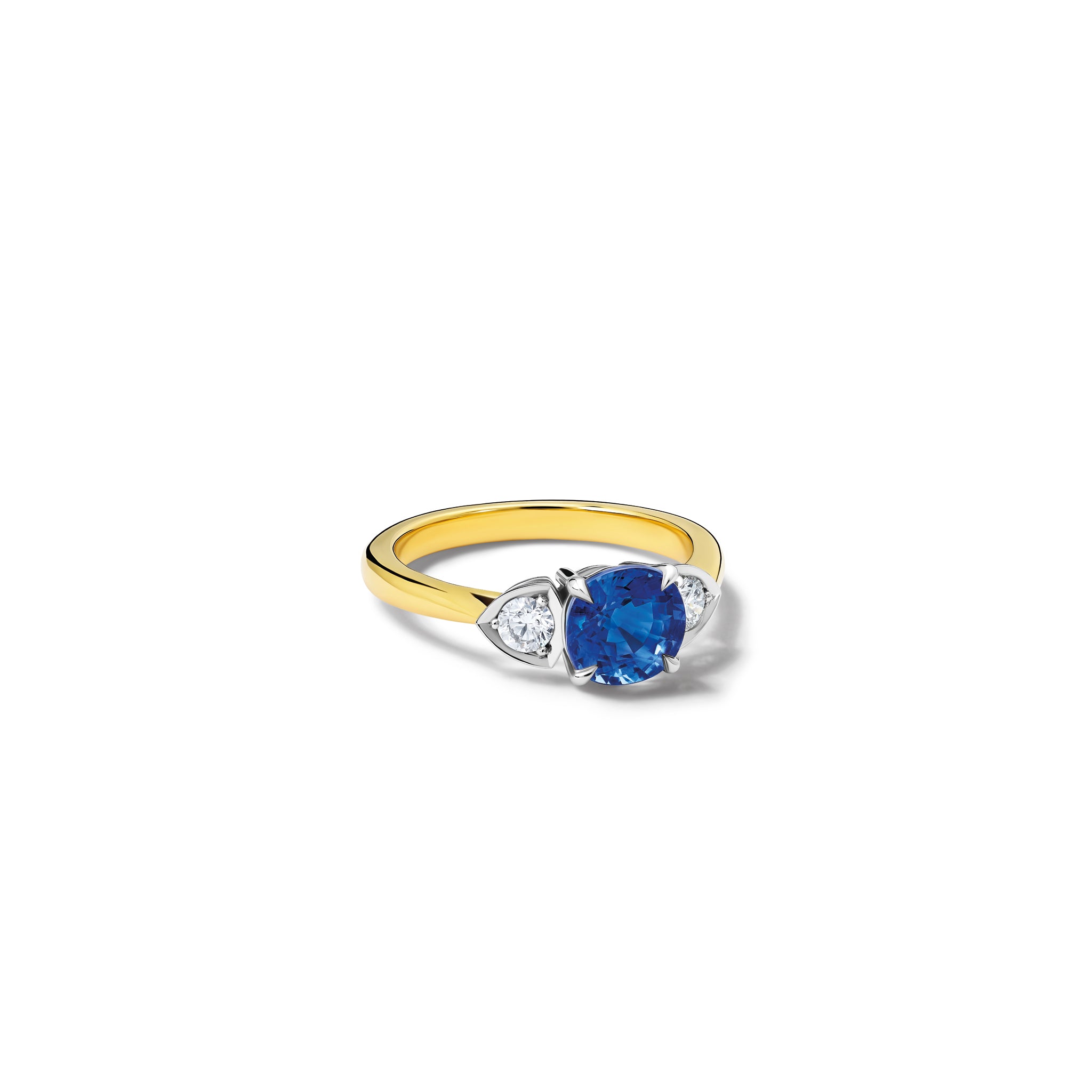 Handcrafted 18ct white and yellow gold engagement ring featuring a large central round sapphire flanked by one smaller teardrop-shaped diamond on each side.