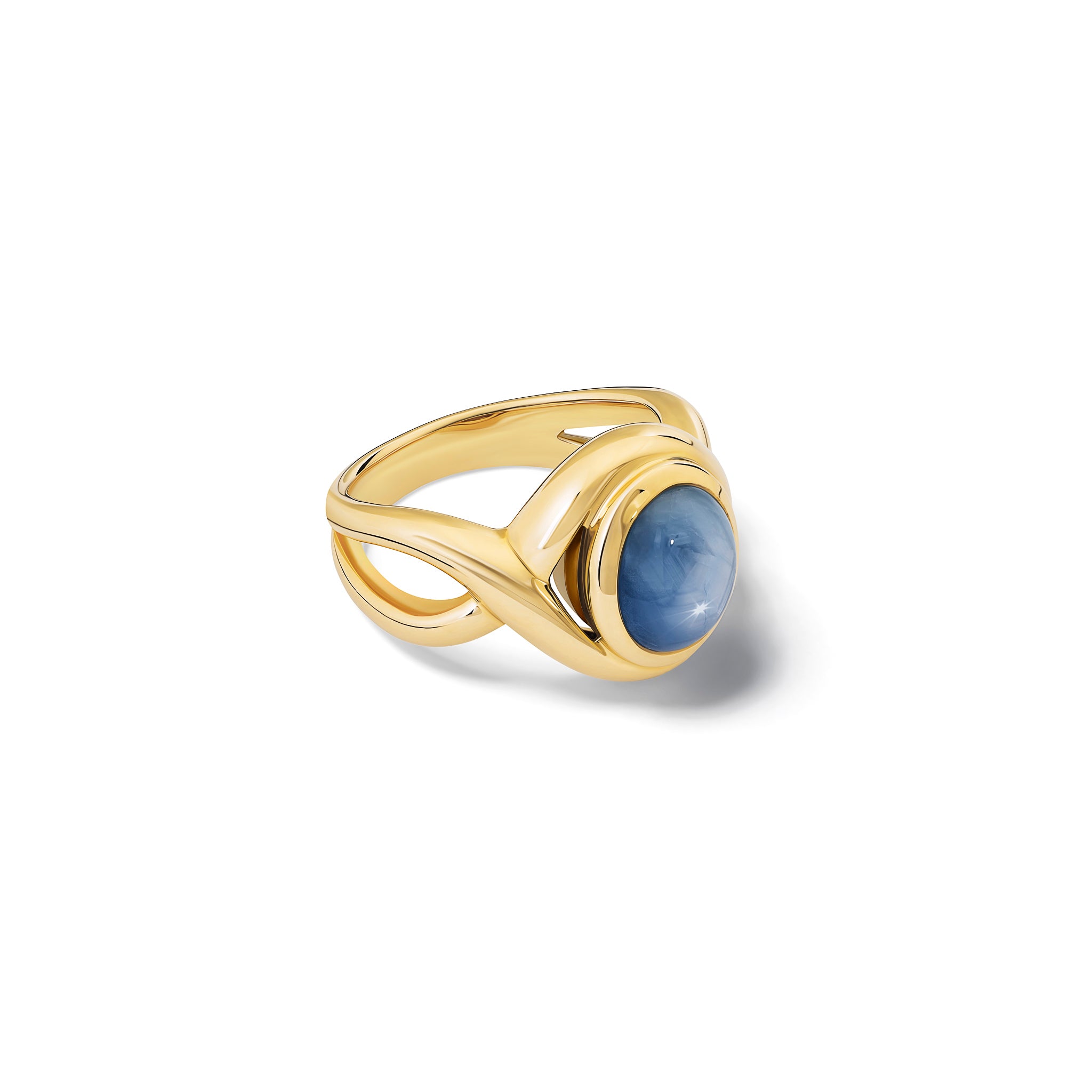Handcrafted yellow gold ring featuring curved shanks with a round cabochon star sapphire.