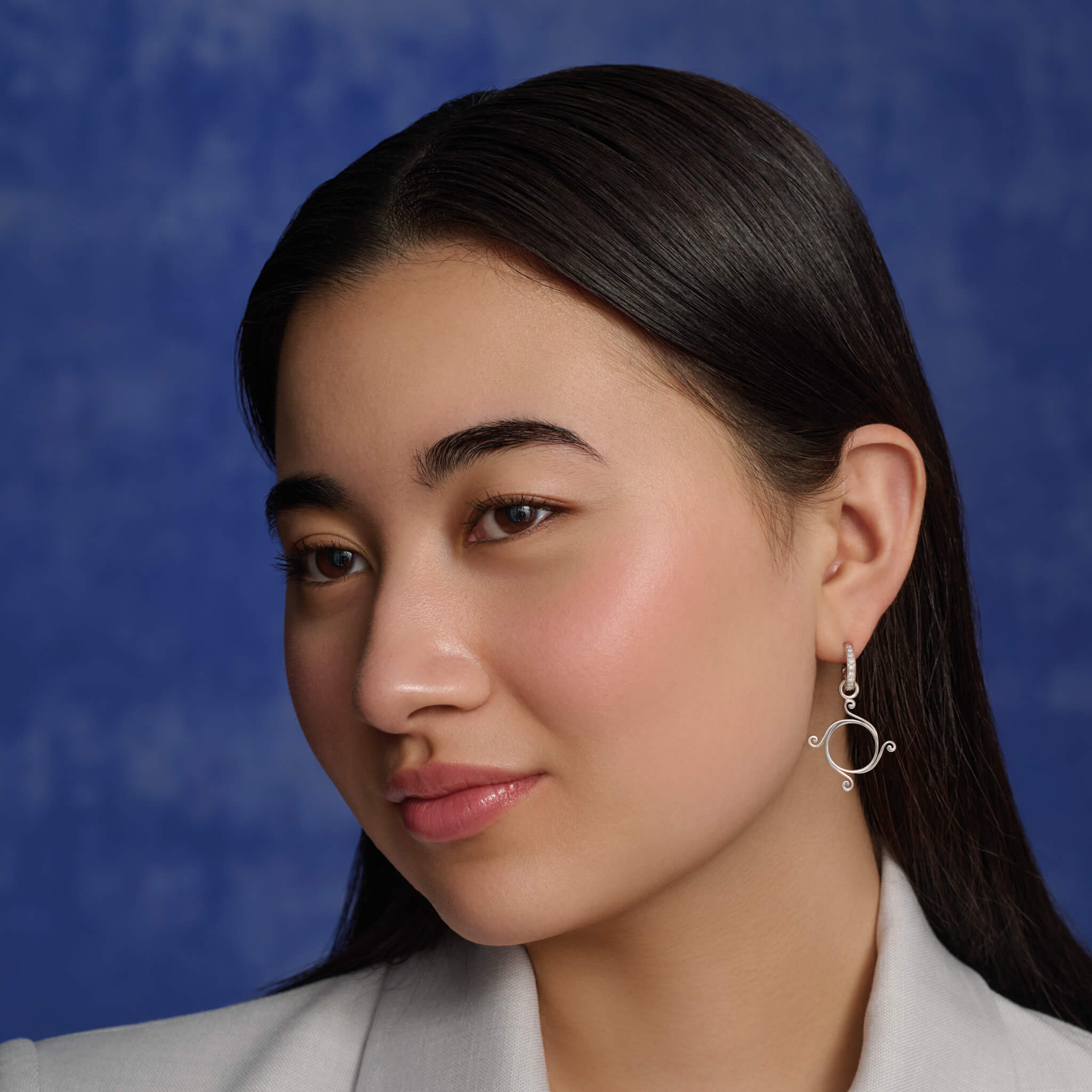 Model wears the handcrafted Athena small earring drops in silver