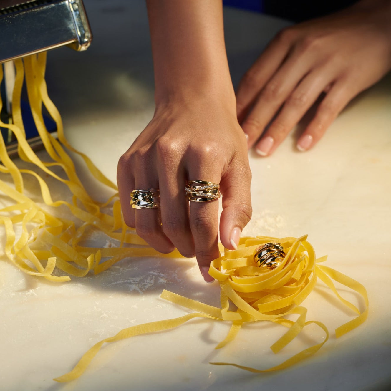 Model wearing a handcrafted sterling silver ring featuring a nest of tagliatelle.