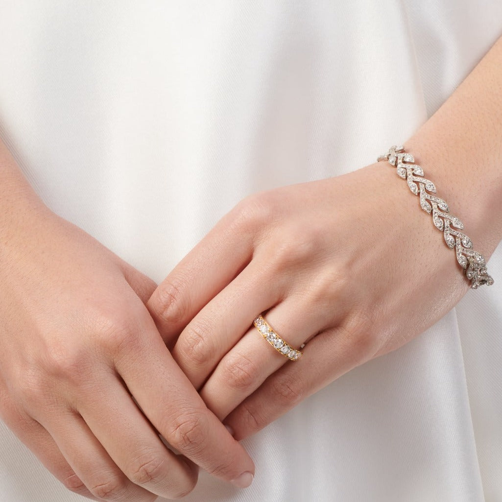 Model wearing a handcrafted 18ct white gold bracelet featuring a rosemary shape with diamonds.