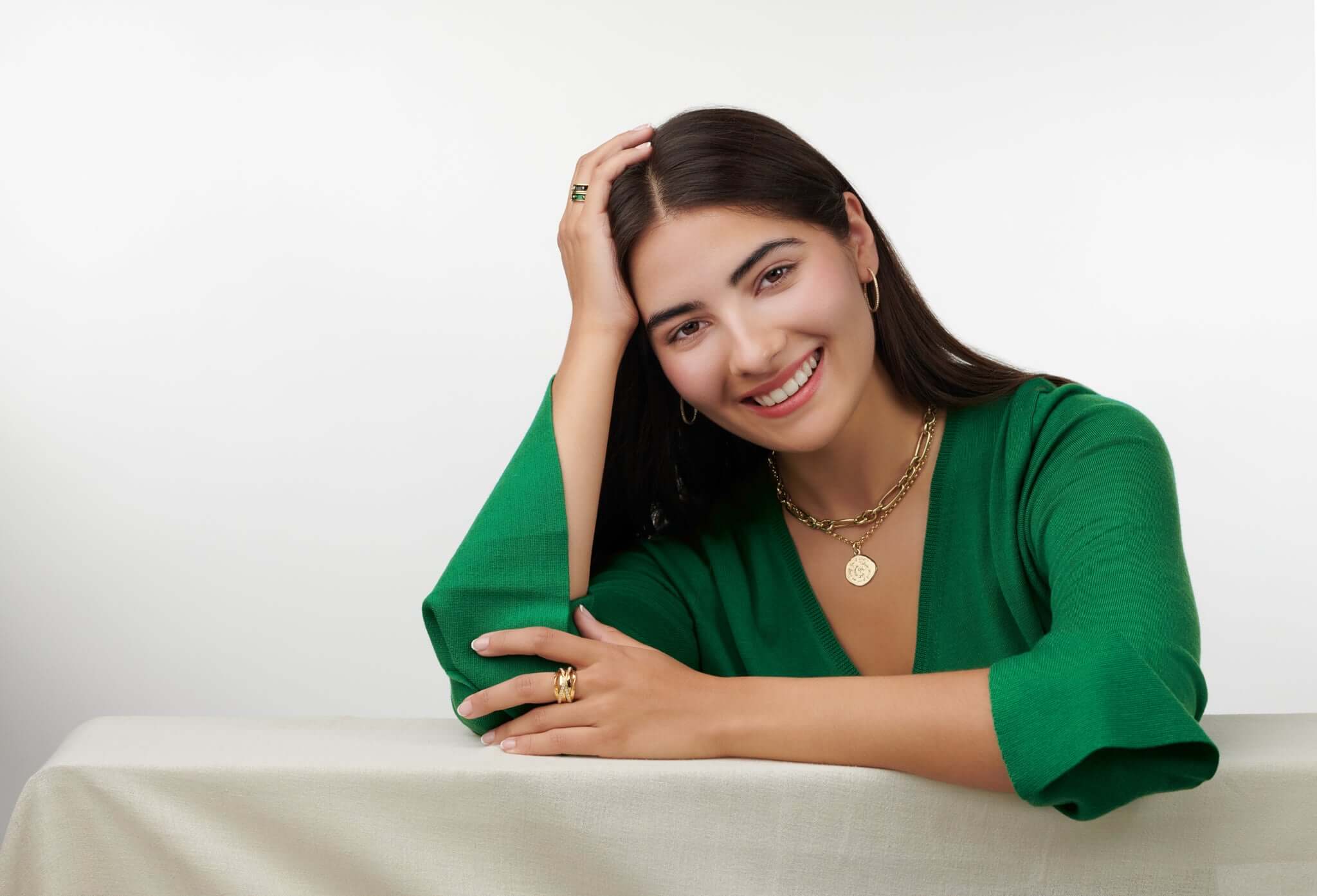 Model wearing handcrafted yellow gold jewellery perfect for graduation, with personalisation available.