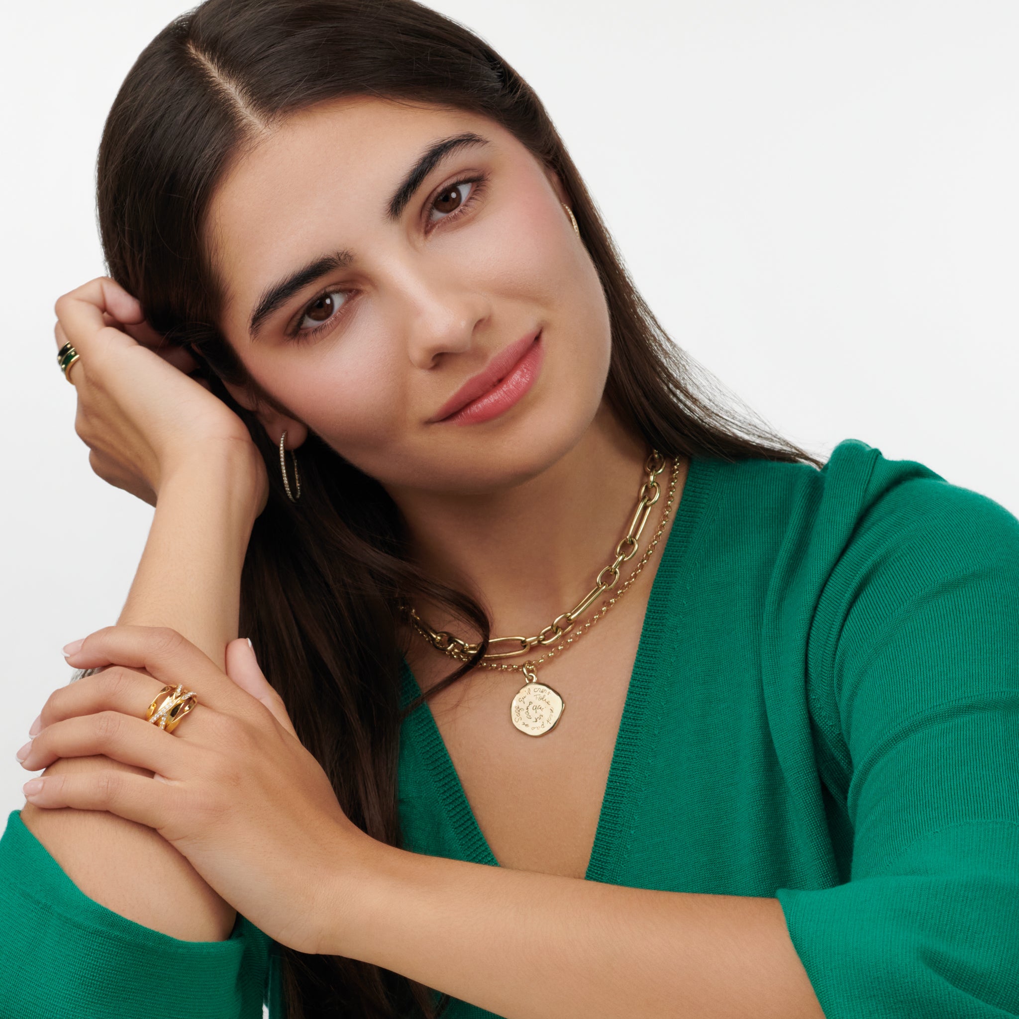 Model wearing a handcrafted round yellow gold necklace pendant engraved with a quote.
