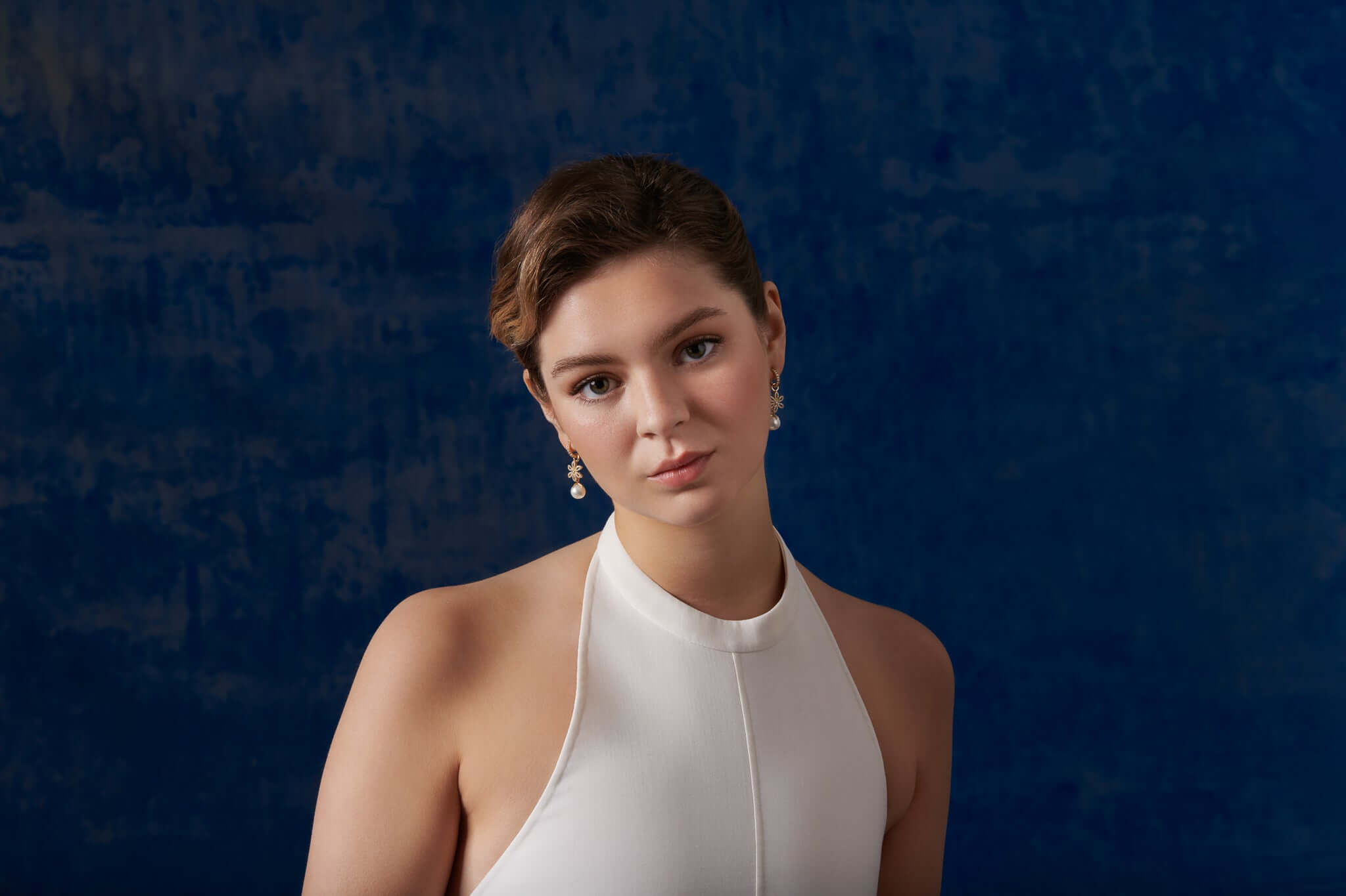 Model wearing handcrafted yellow gold earring drops with earring pendants, showcasing all earring jewellery and the interchangeable qualities.
