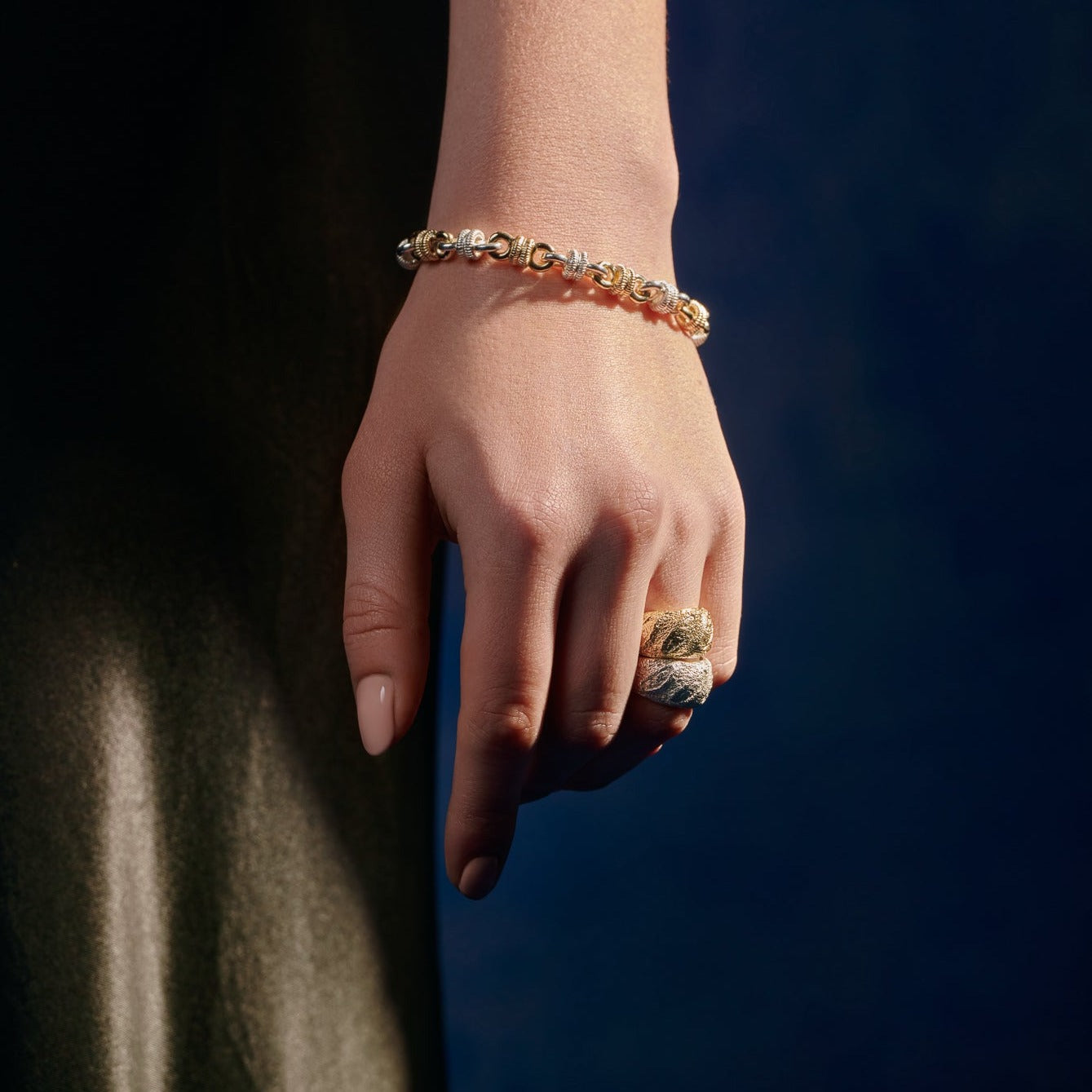 Model wearing handcrafted yellow gold ring with a texture of a freshly baked baguette.
