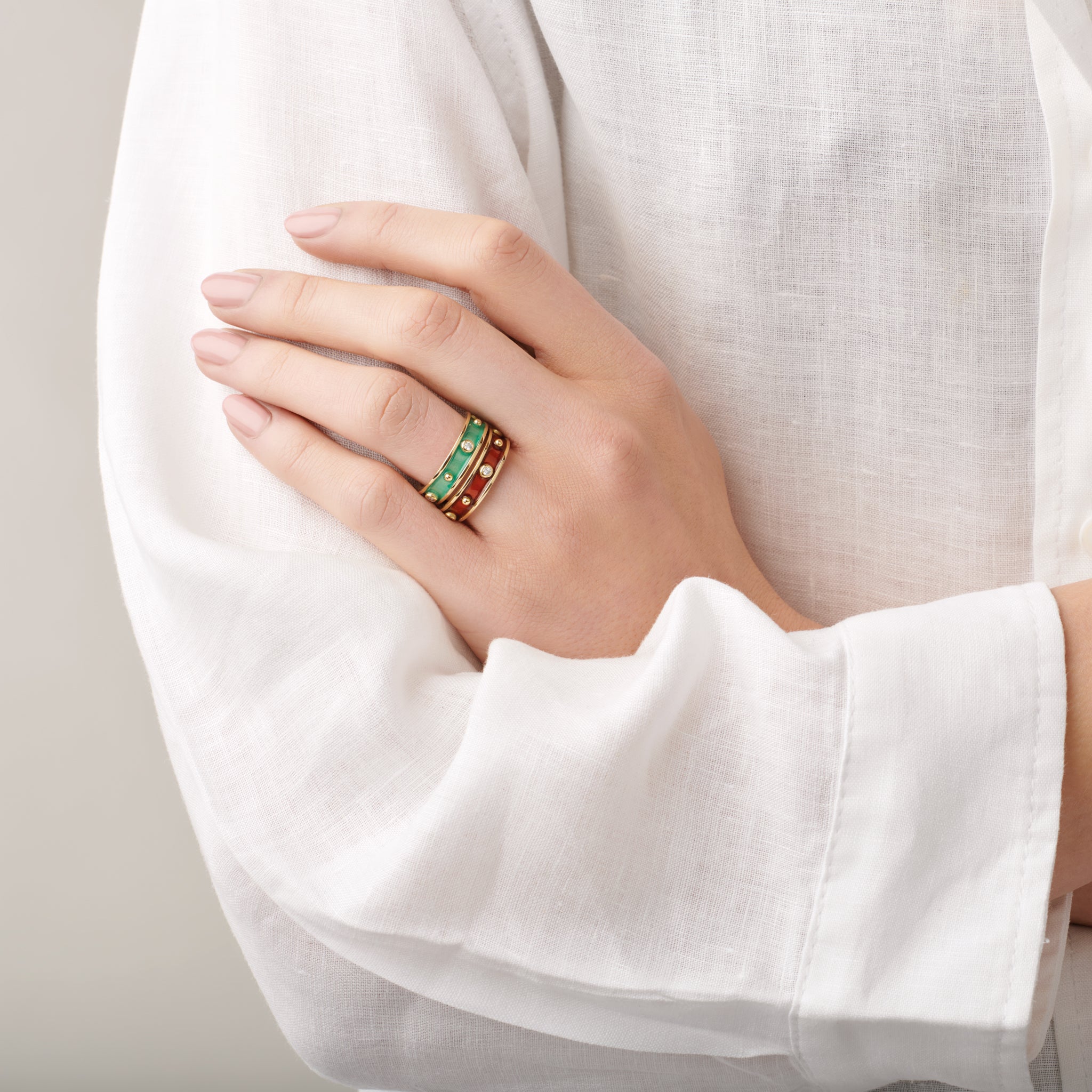 Model wearing handcrafted 18ct yellow gold rings with evenly spaced, protruding round dots with diamonds.