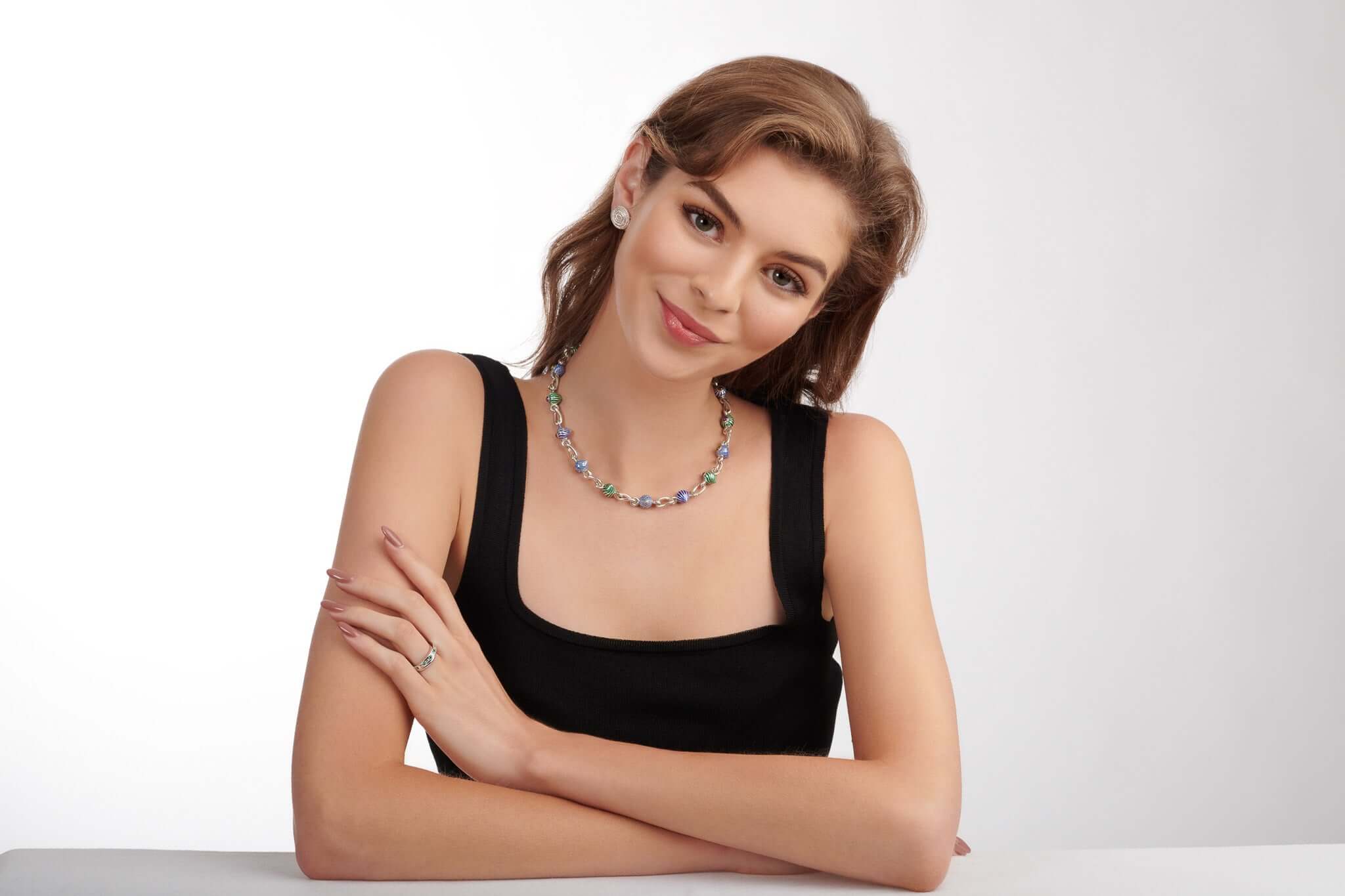 Model wearing handcrafted silver jewellery with enamel.
