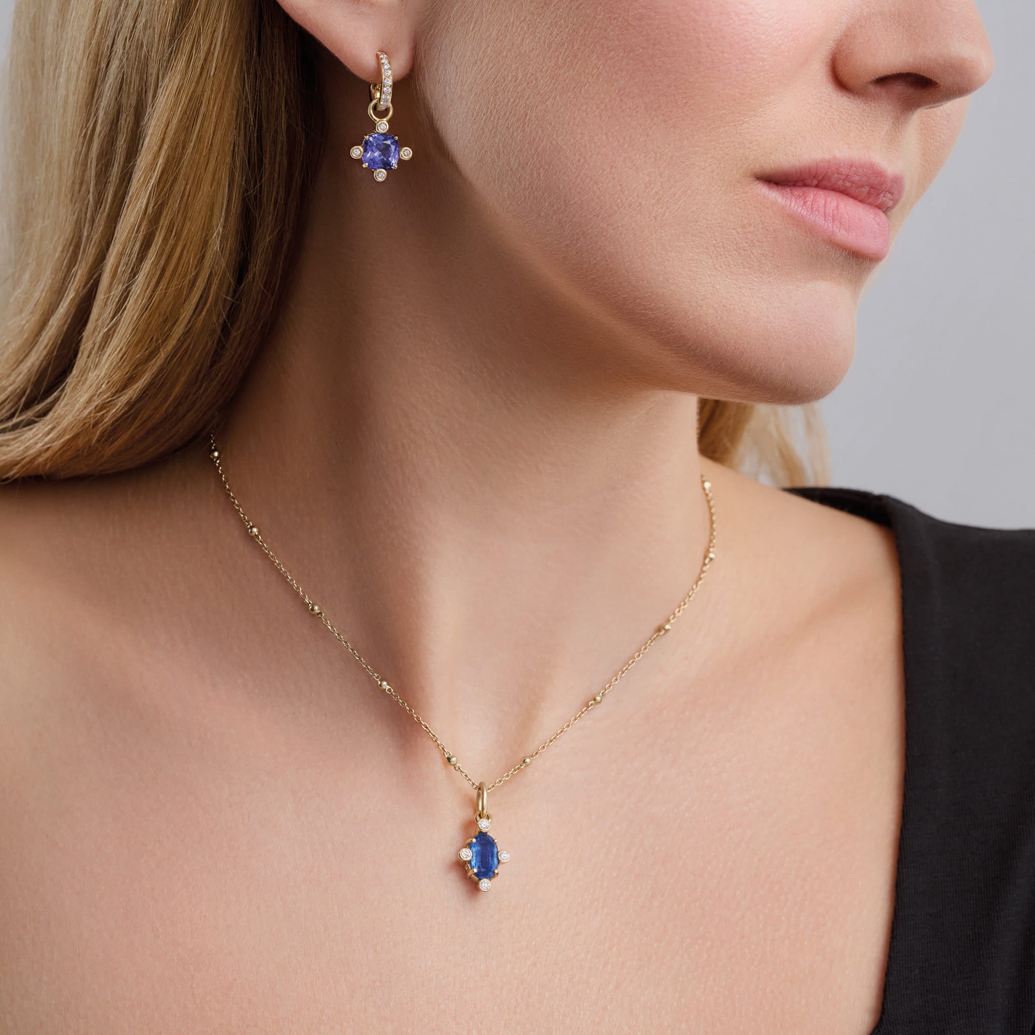 Model wears Handcrafted 18ct yellow gold pendant with medium facetted rare oval kyanite set with four diamonds