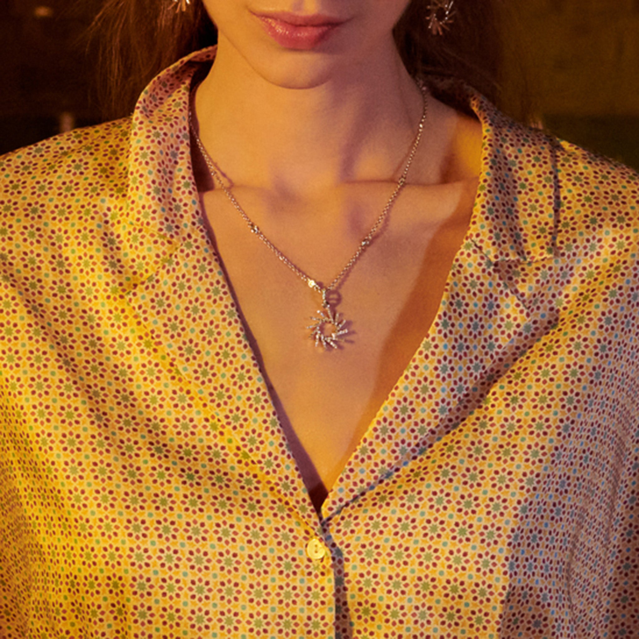 Handcrafted 18ct yellow gold necklace pendant featuring a circular shape of diagonal lines with diamonds.