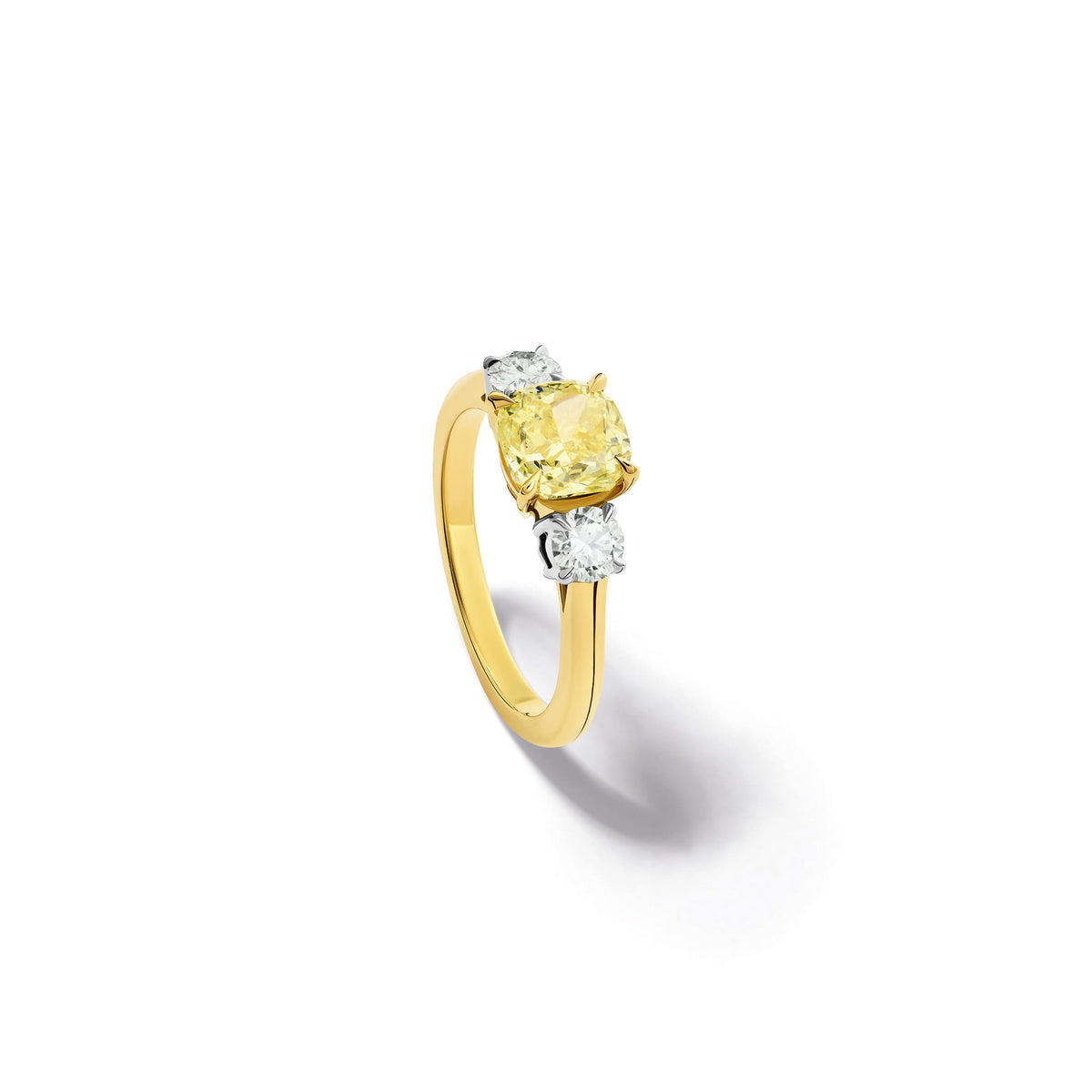 Handcrafted yellow gold yellow diamond engagement ring with two diamonds set in white gold on each side