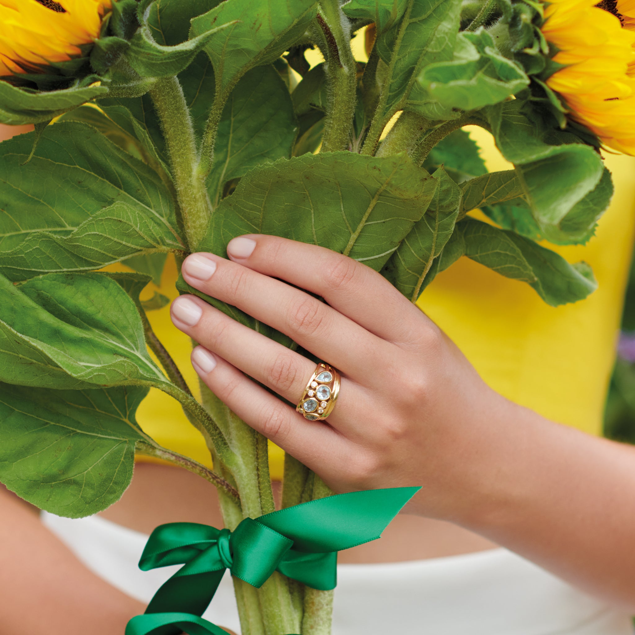 Model wearing a handcrafted 18ct yellow gold wedding band with a width of 2mm.