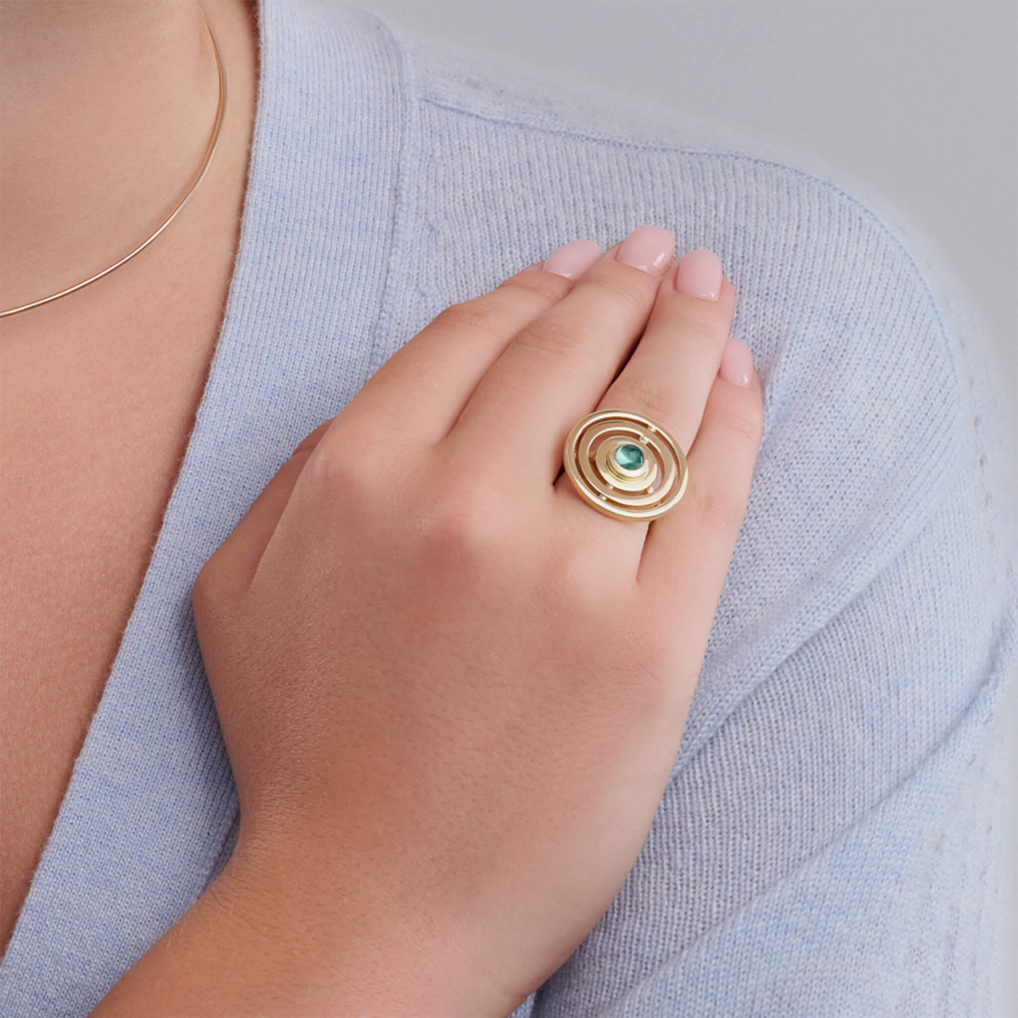 Handcrafted 9ct yellow gold cocktail ring featuring three concentric circles with movement and a central cabochon green tourmaline.