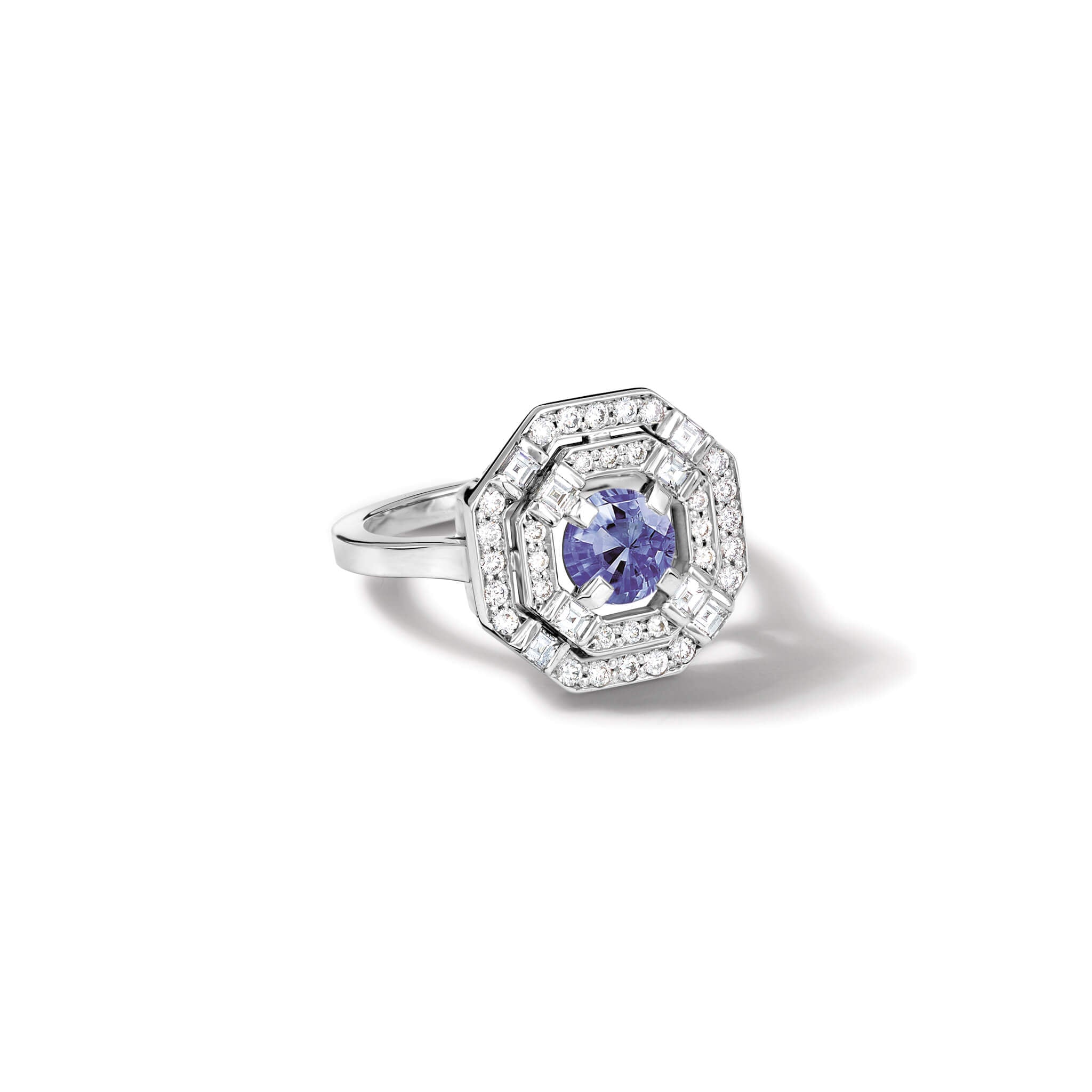 Handcrafted 18ct white gold engagement ring featuring a central square-cut central sapphire, surrounded by two tiers of small round diamonds set in a hexagonal pattern.