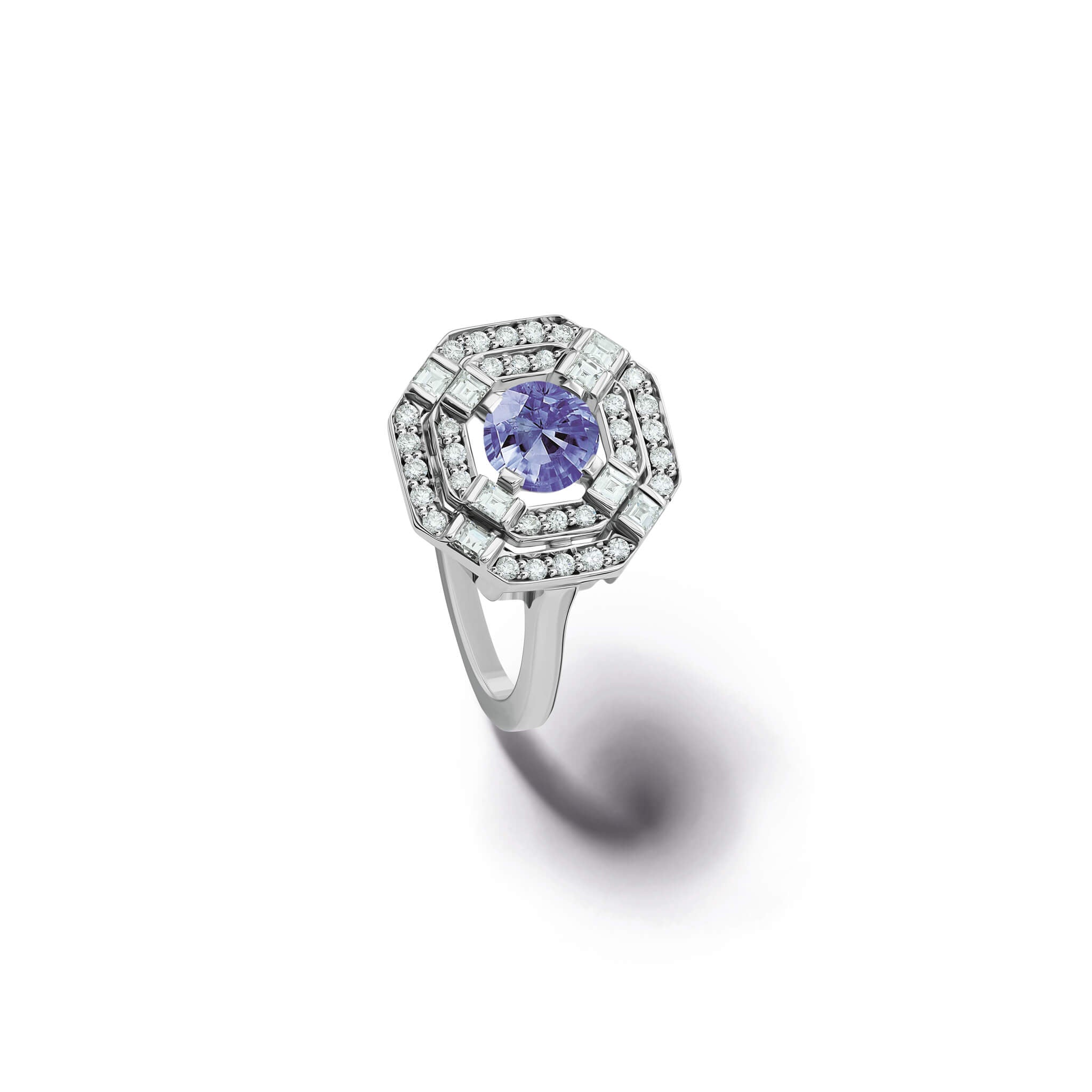 Handcrafted 18ct white gold engagement ring featuring a central square-cut central sapphire, surrounded by two tiers of small round diamonds set in a hexagonal pattern.